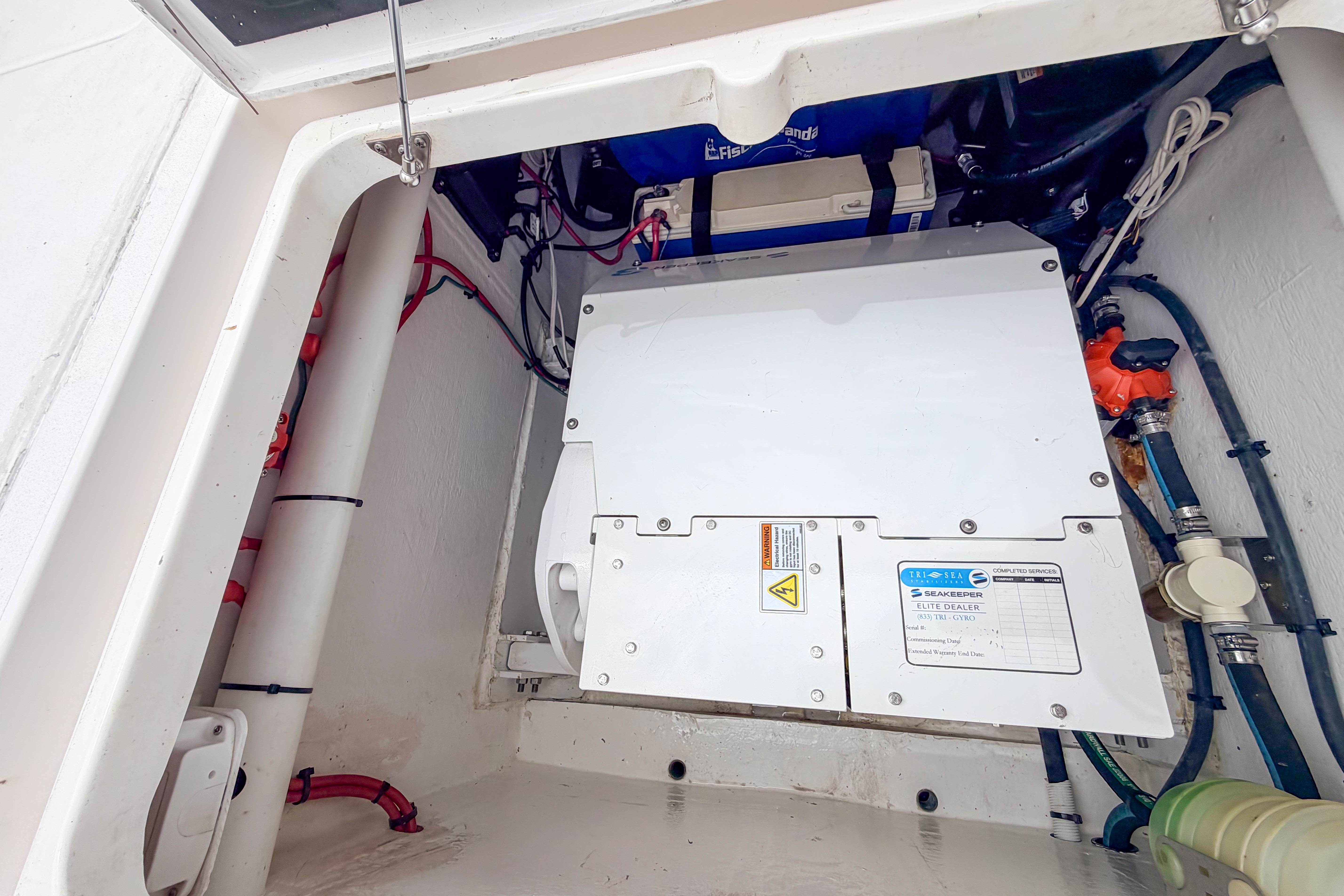 Engine compartment of a 2021 Intrepid 409 Valor boat, featuring Seakeeper stabilization system.