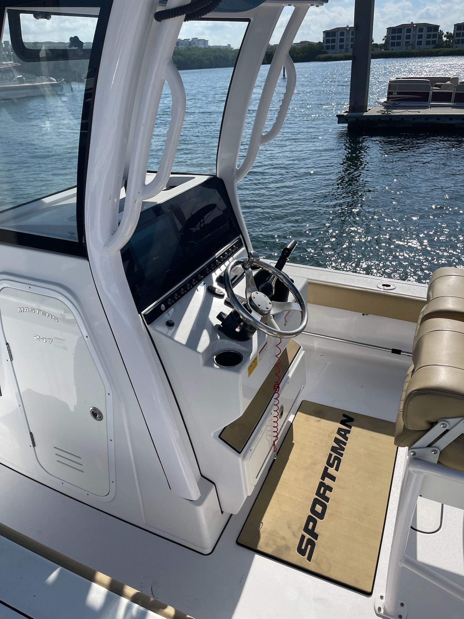 The image shows the cockpit of a 2022 Sportsman Masters 247 Bay Boat with a helm console.