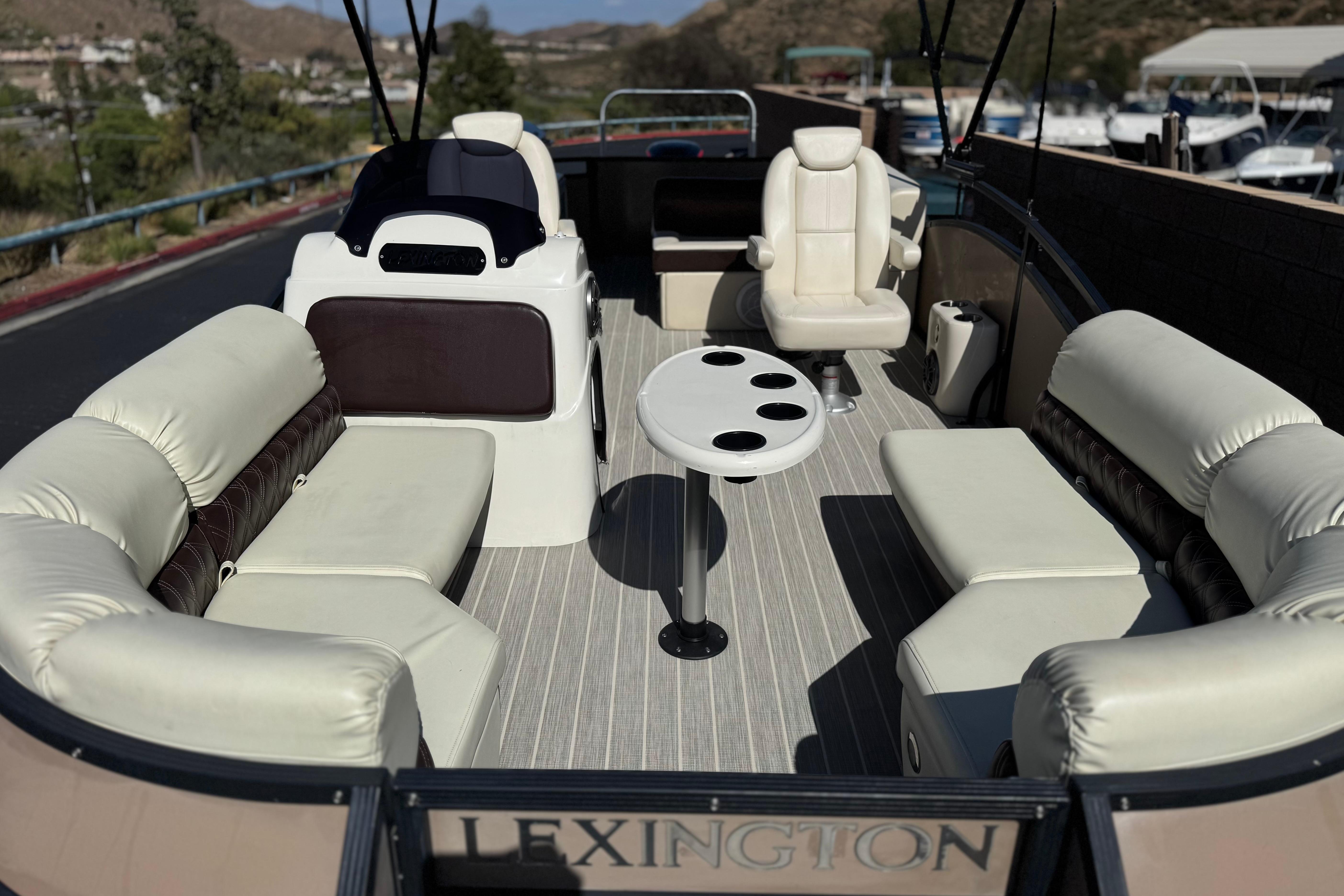 Luxurious 2023 Lexington 623 ST Xtreme pontoon boat interior with plush seating and cup holders.