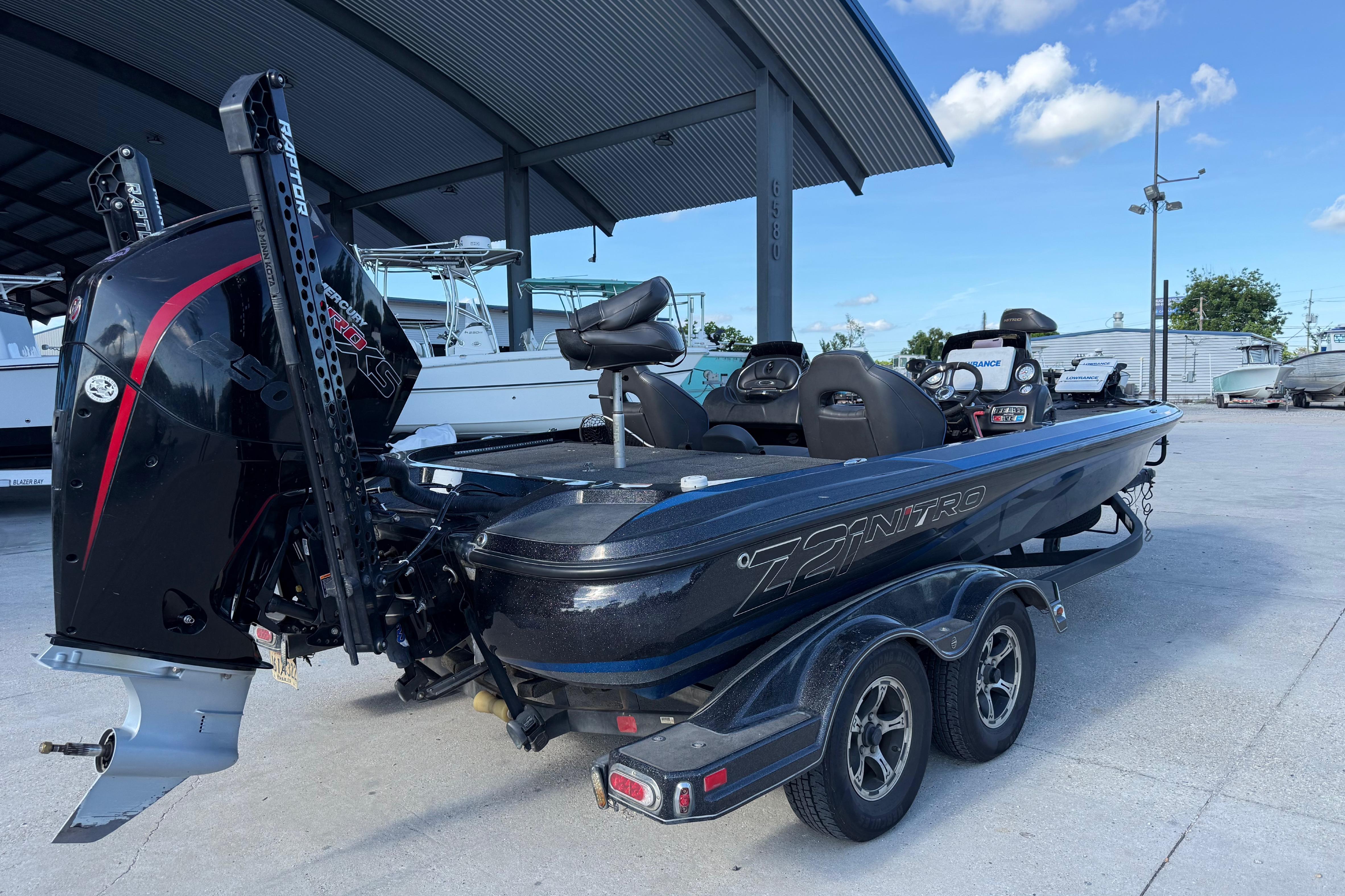 2018 Nitro Z21 boat with powerful engine, parked under a metal canopy.
