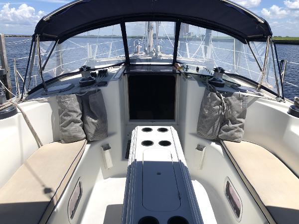 Jeanneau 45.2 sailboat cockpit, 2001 model, with seating and canopy, on open water.