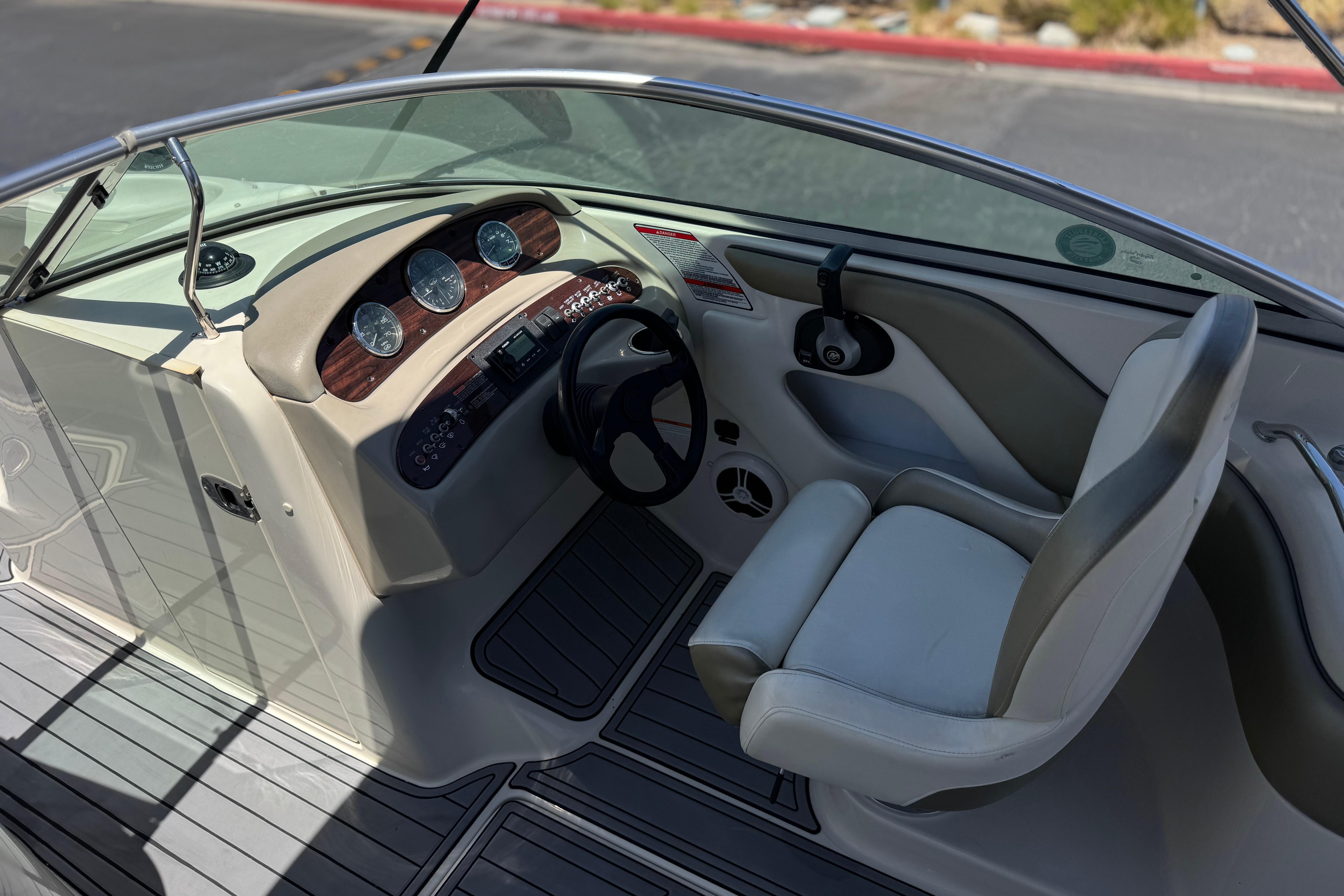 2007 Sea Ray 240 Sundeck boat cockpit with steering wheel and gauges.