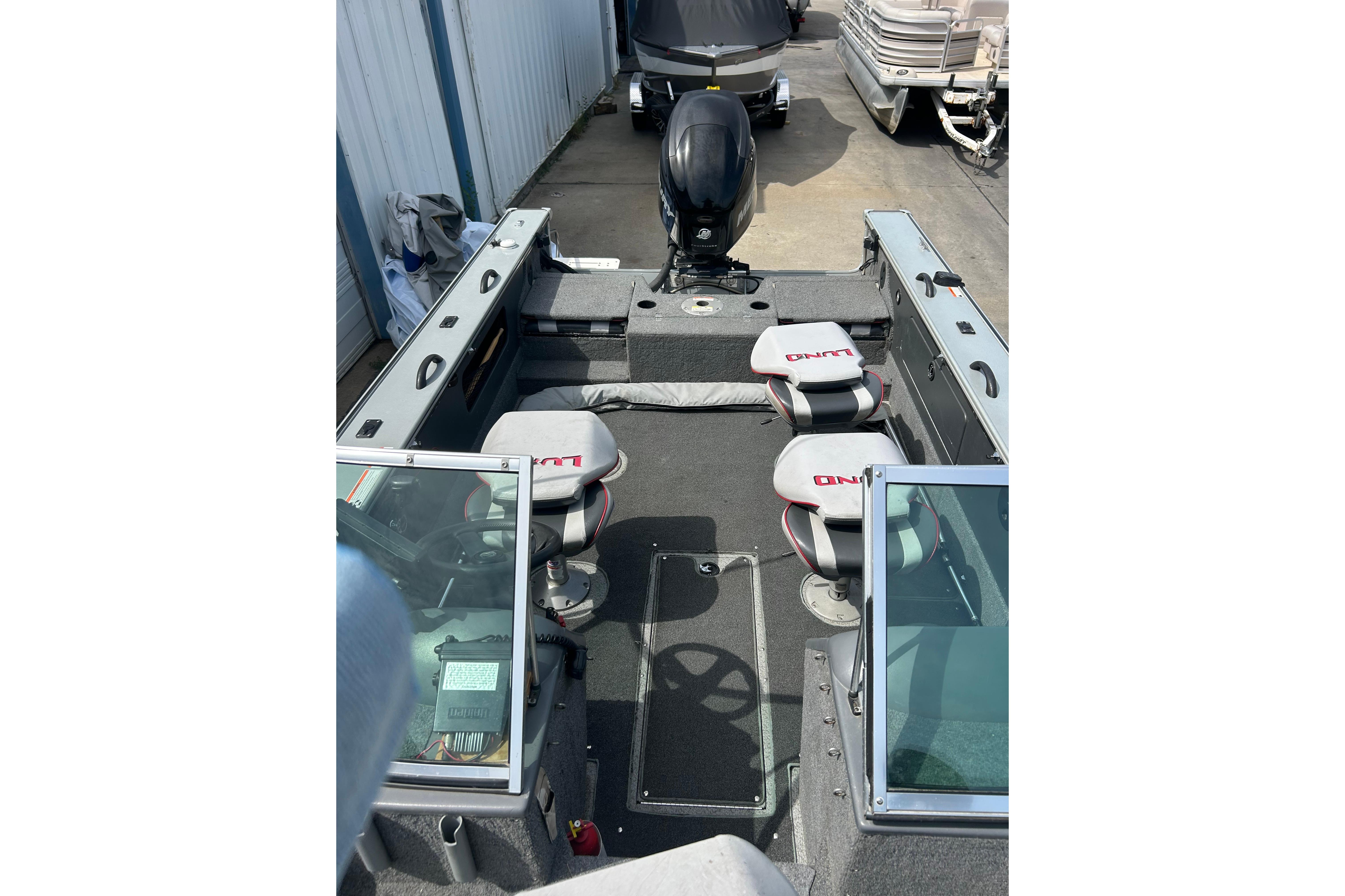 2008 Lund 1850 Fisherman boat interior with seating and steering console.