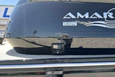 2025 SunCatcher Amara boat rear view with logo and reflection.