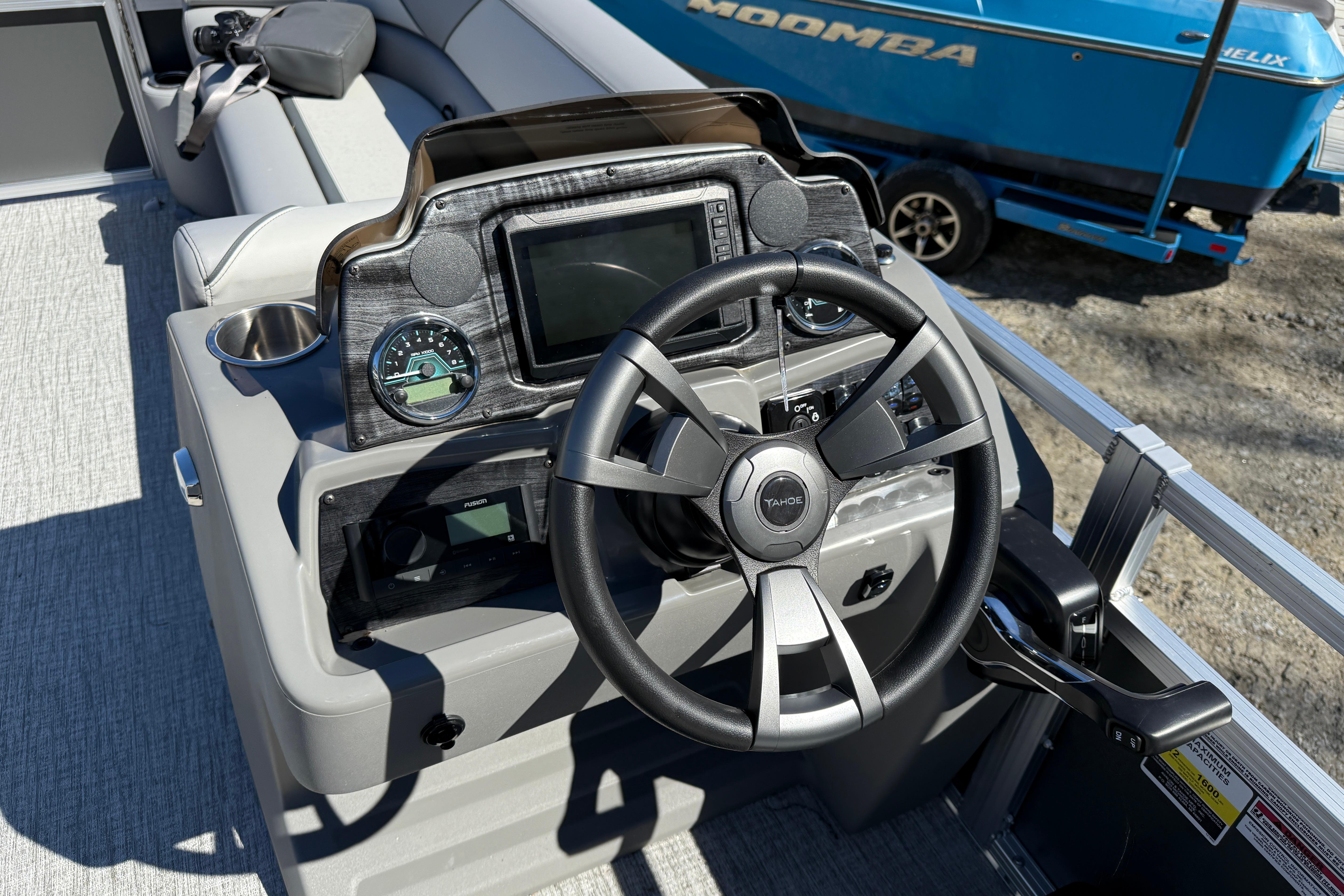 Steering console of 2026 Tahoe Pontoon Sport 85 Rear Fish boat, featuring modern controls.