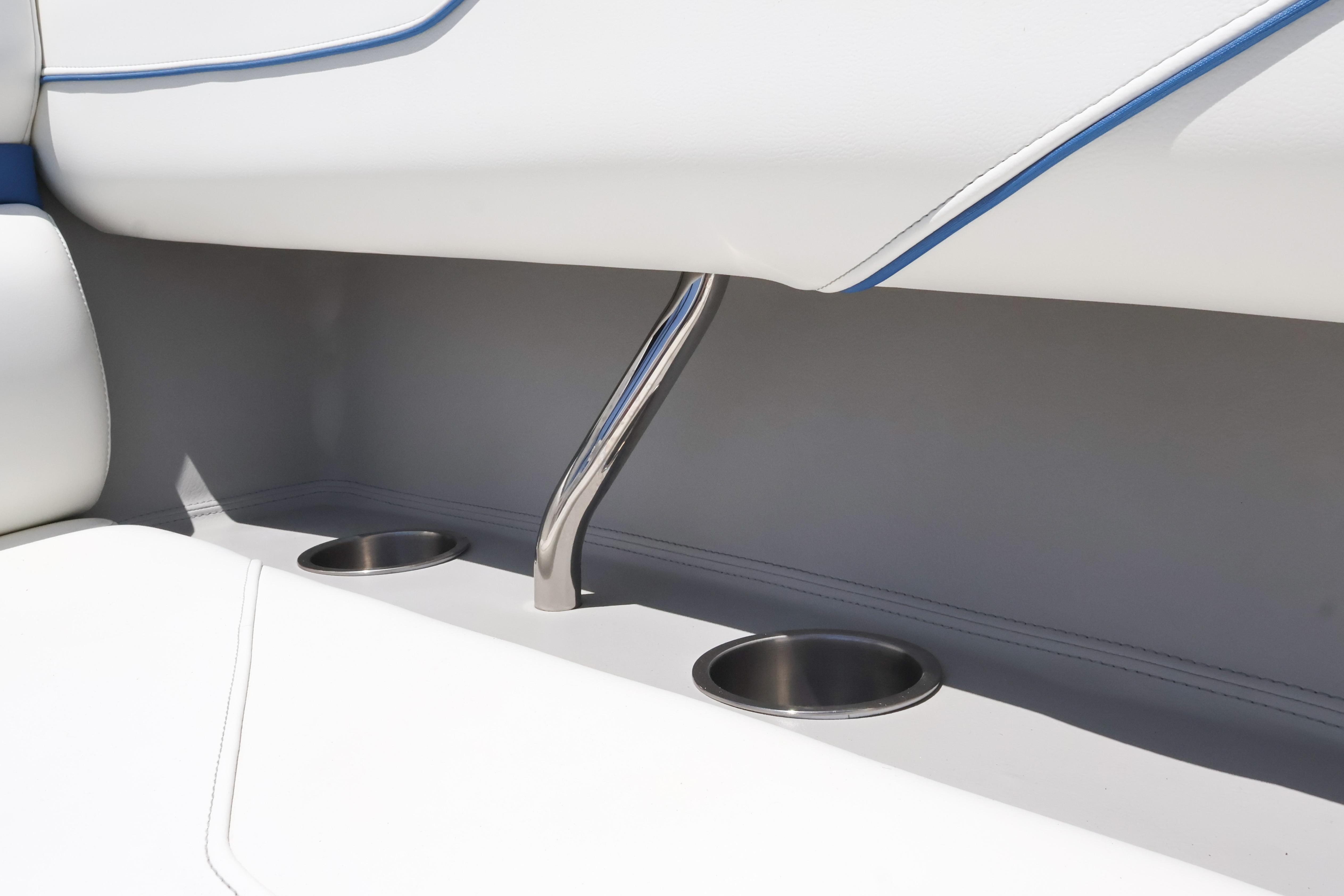 2020 Regal LX4 boat interior with stainless steel cup holders and white seating.