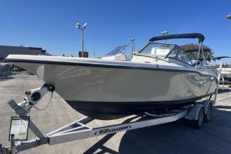 2022 Key West 239 DFS boat on trailer, parked outdoors under clear blue sky.