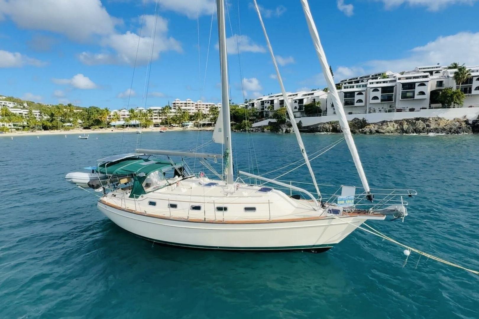 Sailboat Island Packet 370, 2010 model, anchored in scenic coastal waters.