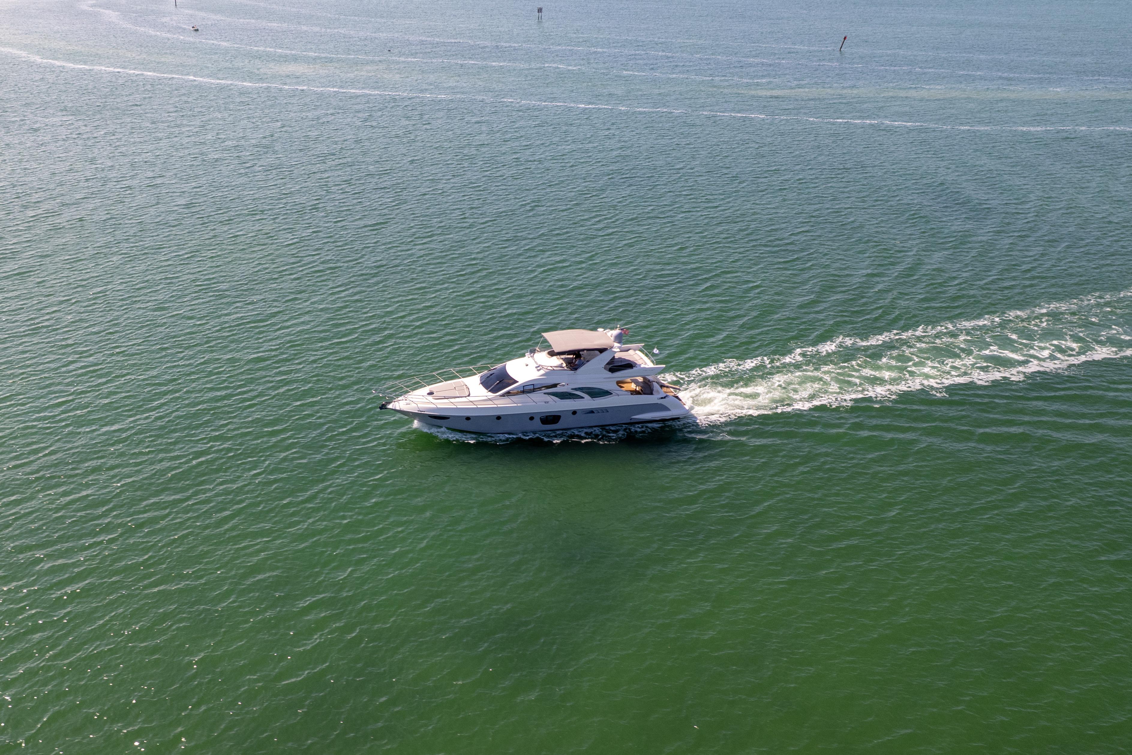 2008 Azimut 62E yacht cruising on open water, leaving a gentle wake.