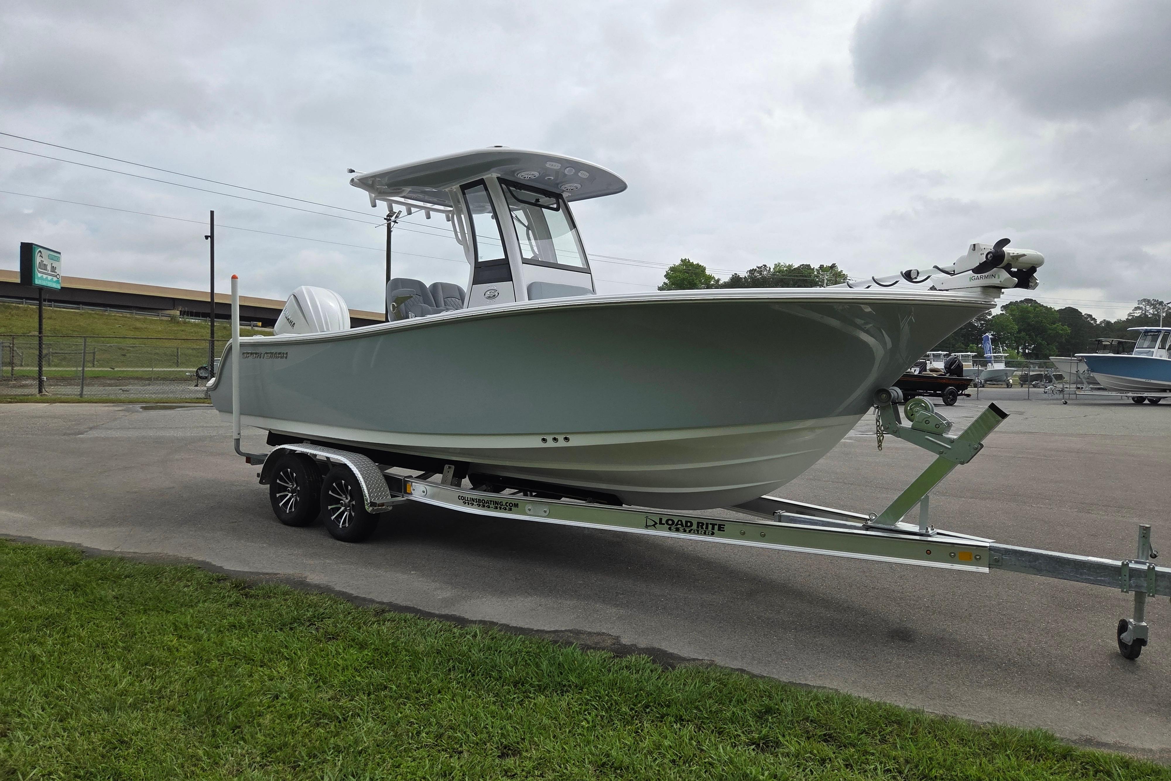 2026 Sportsman Open 232 Center Console boat on trailer, parked outdoors.