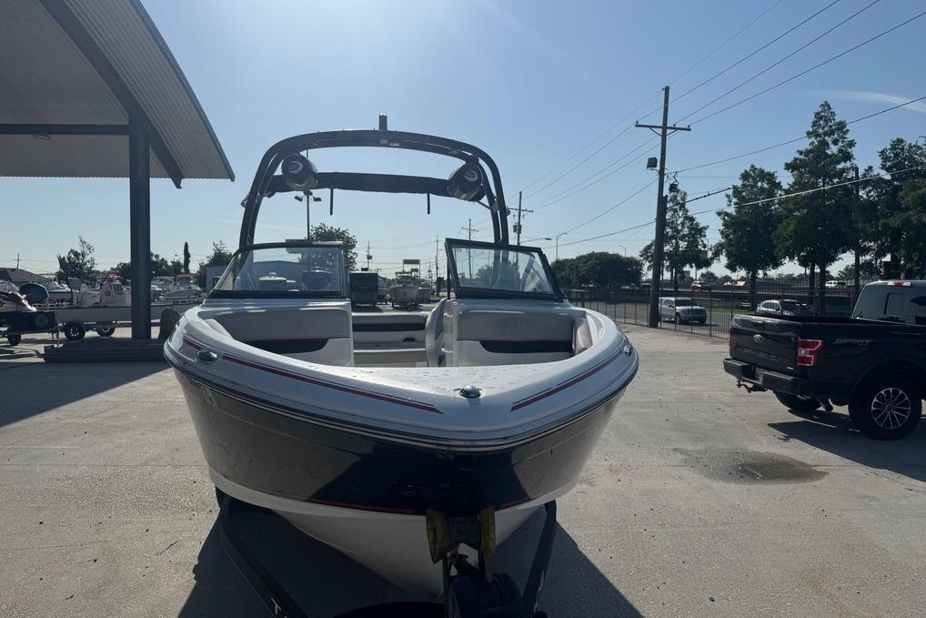 2018 Tahoe 700 TF boat parked outdoors under clear sky.