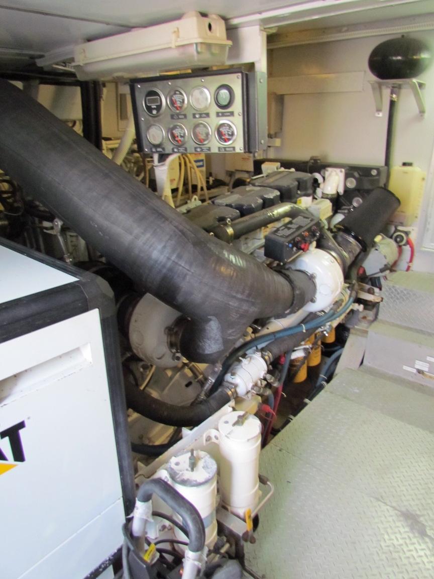 Engine room of a 1972 Hargrave 67 Motor Yacht, featuring gauges and machinery.