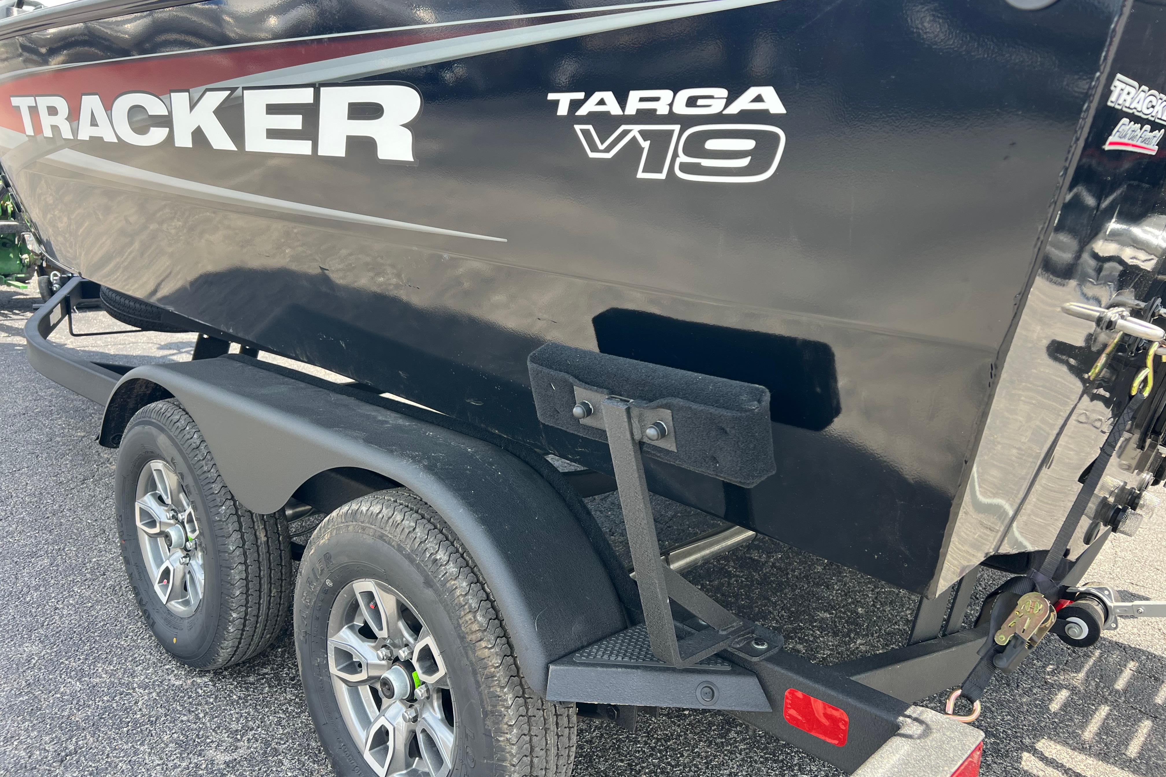 2026 Tracker Targa V-19 Combo boat on trailer, showcasing sleek design and dual wheels.