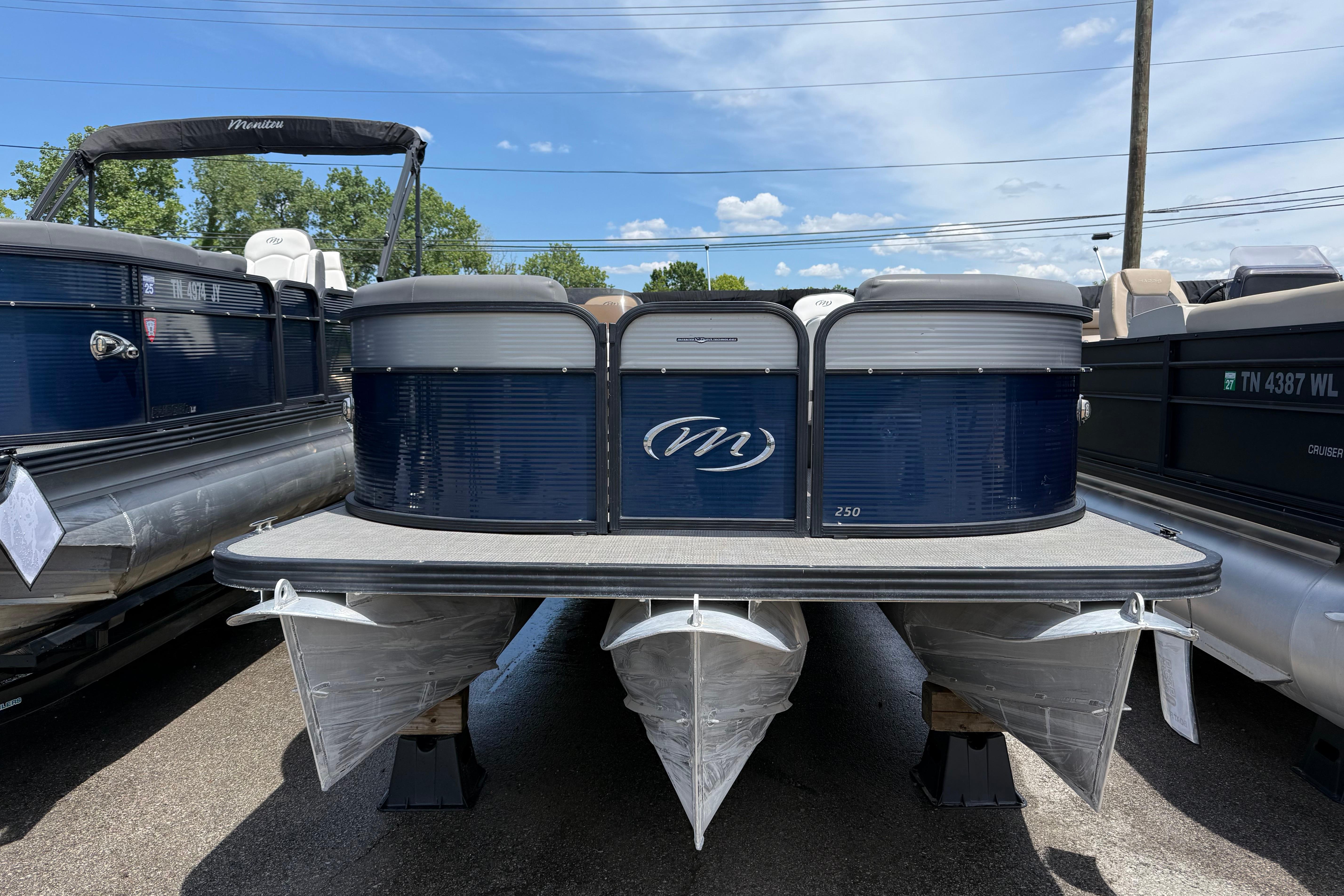 2022 Manitou Aurora LE pontoon boat displayed outdoors on a sunny day.