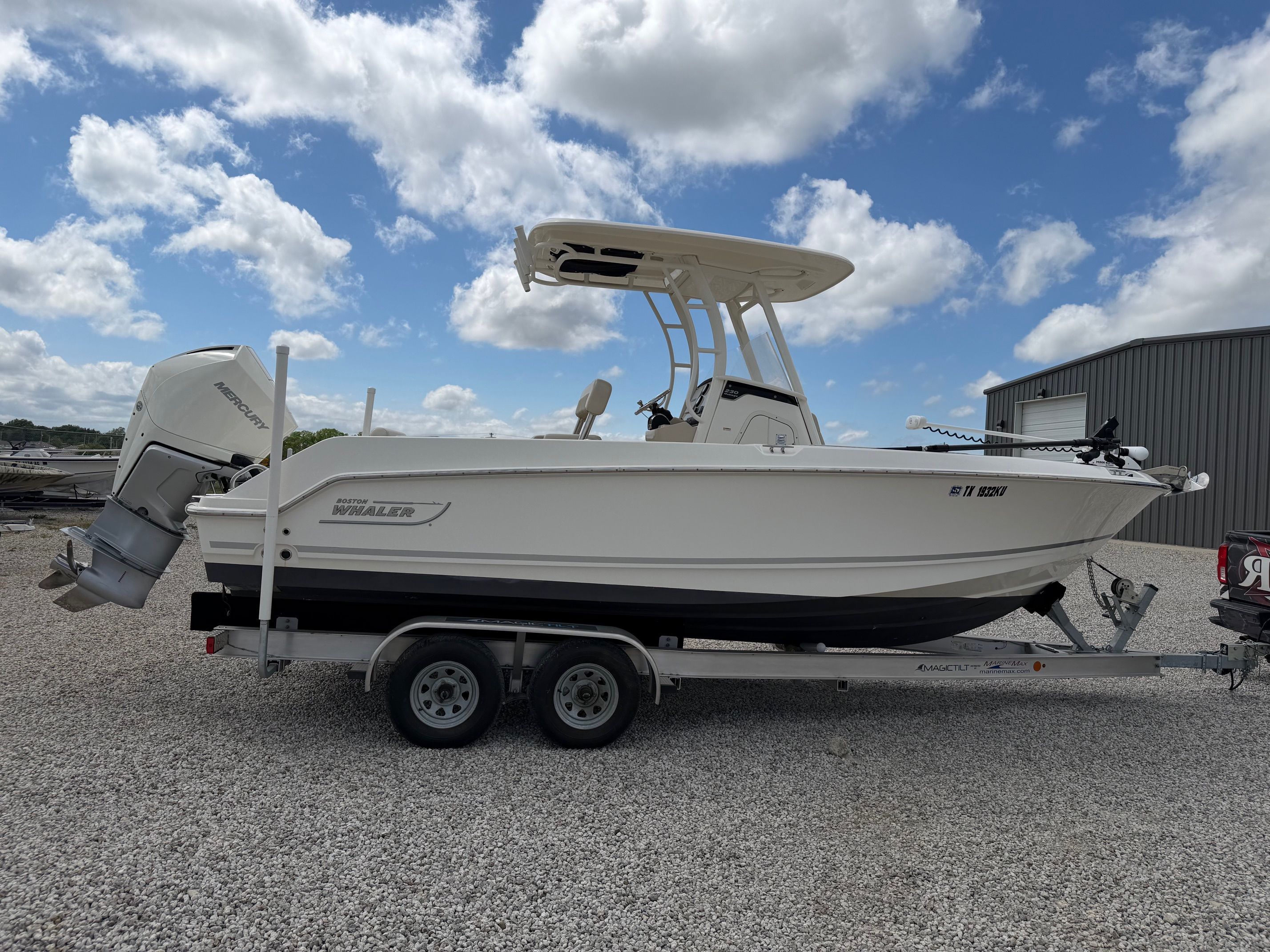 Boston Whaler 230 Outrage 2020 on trailer under blue sky.