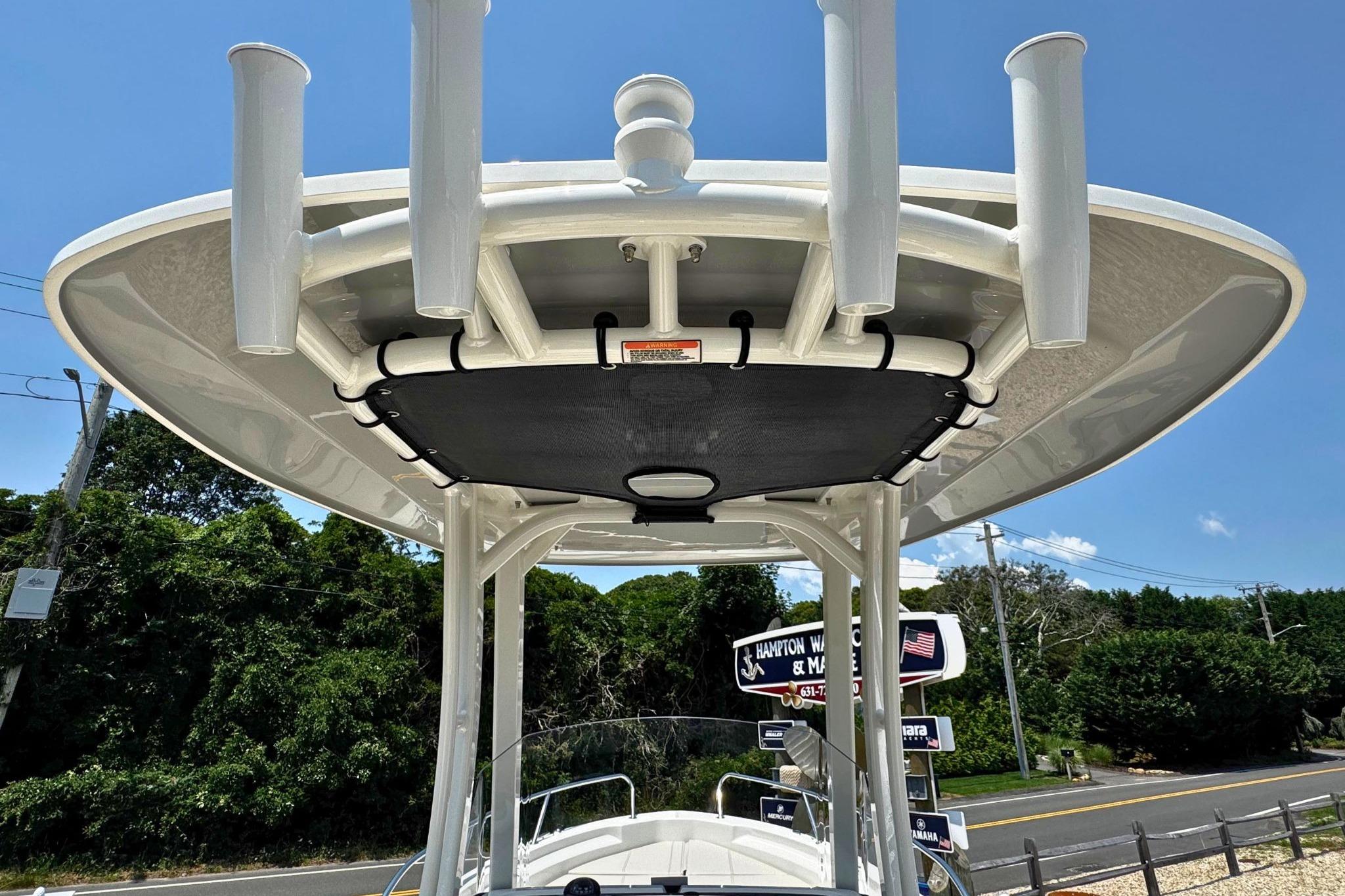 Boston Whaler 220 Dauntless 2026 boat with rod holders and canopy, viewed from below.