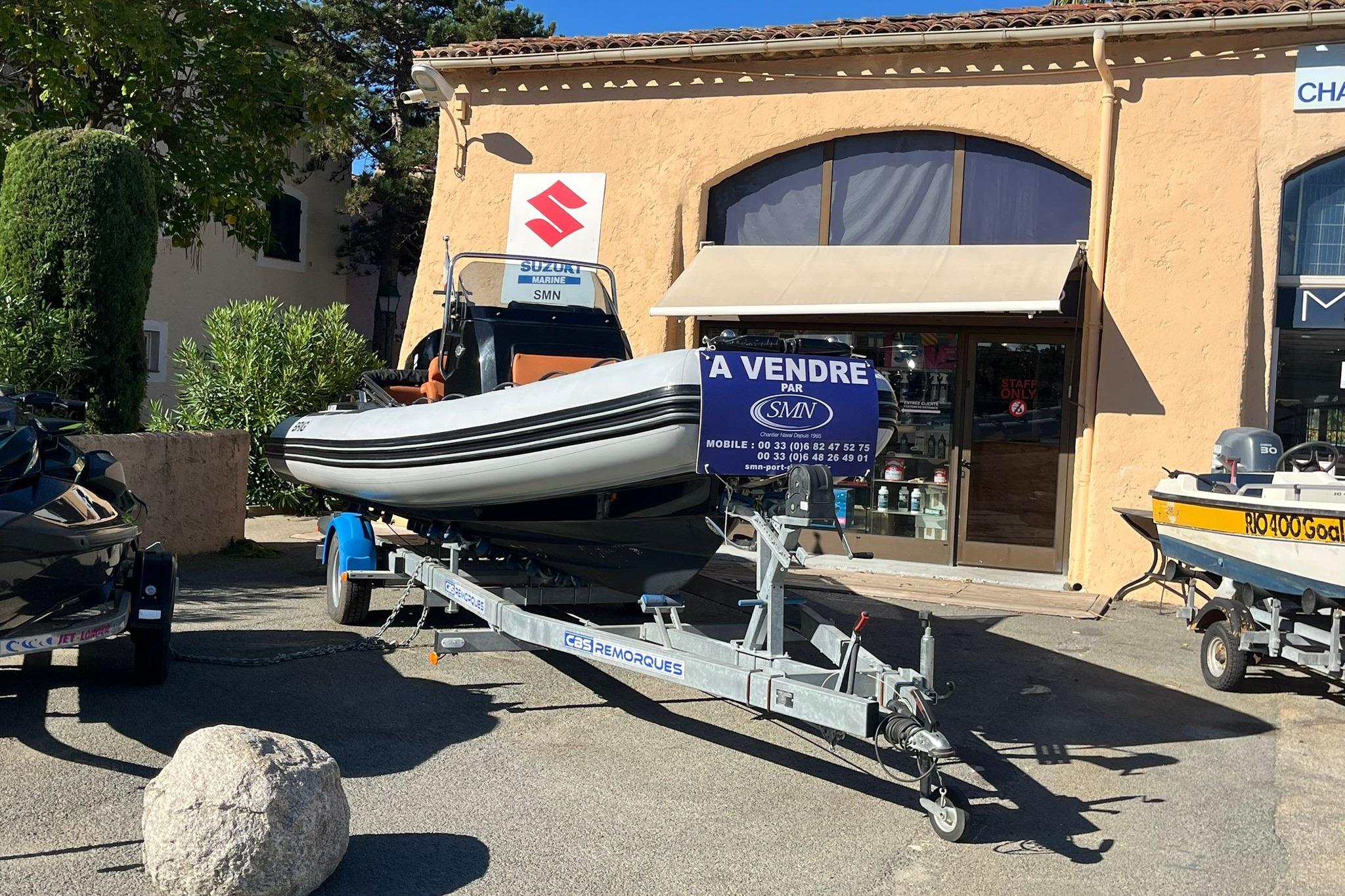 2022 Brig Eagle 6.7 boat for sale on trailer outside marine shop.