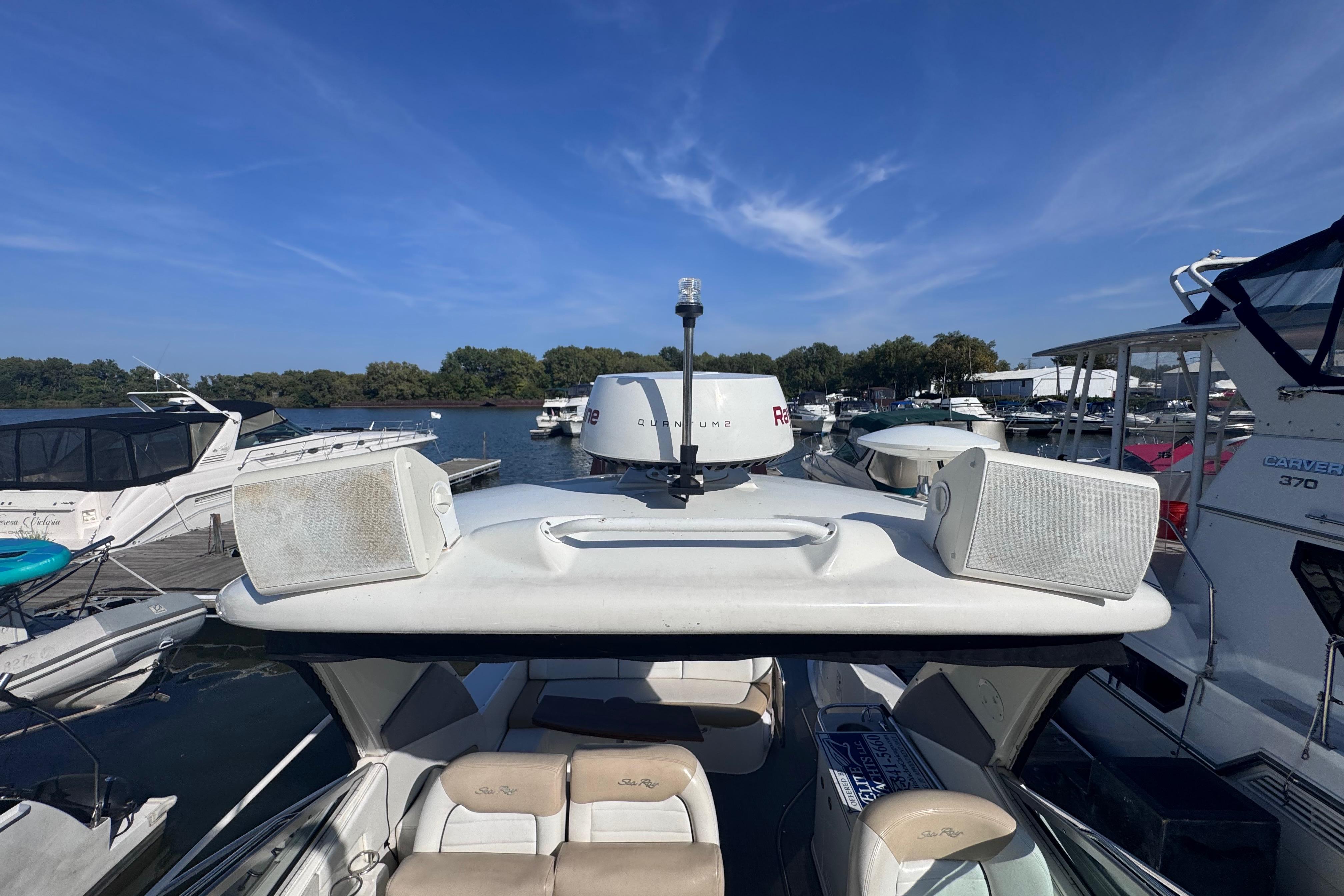 2008 Sea Ray 350 Sundancer docked at marina, surrounded by other boats under clear blue sky.
