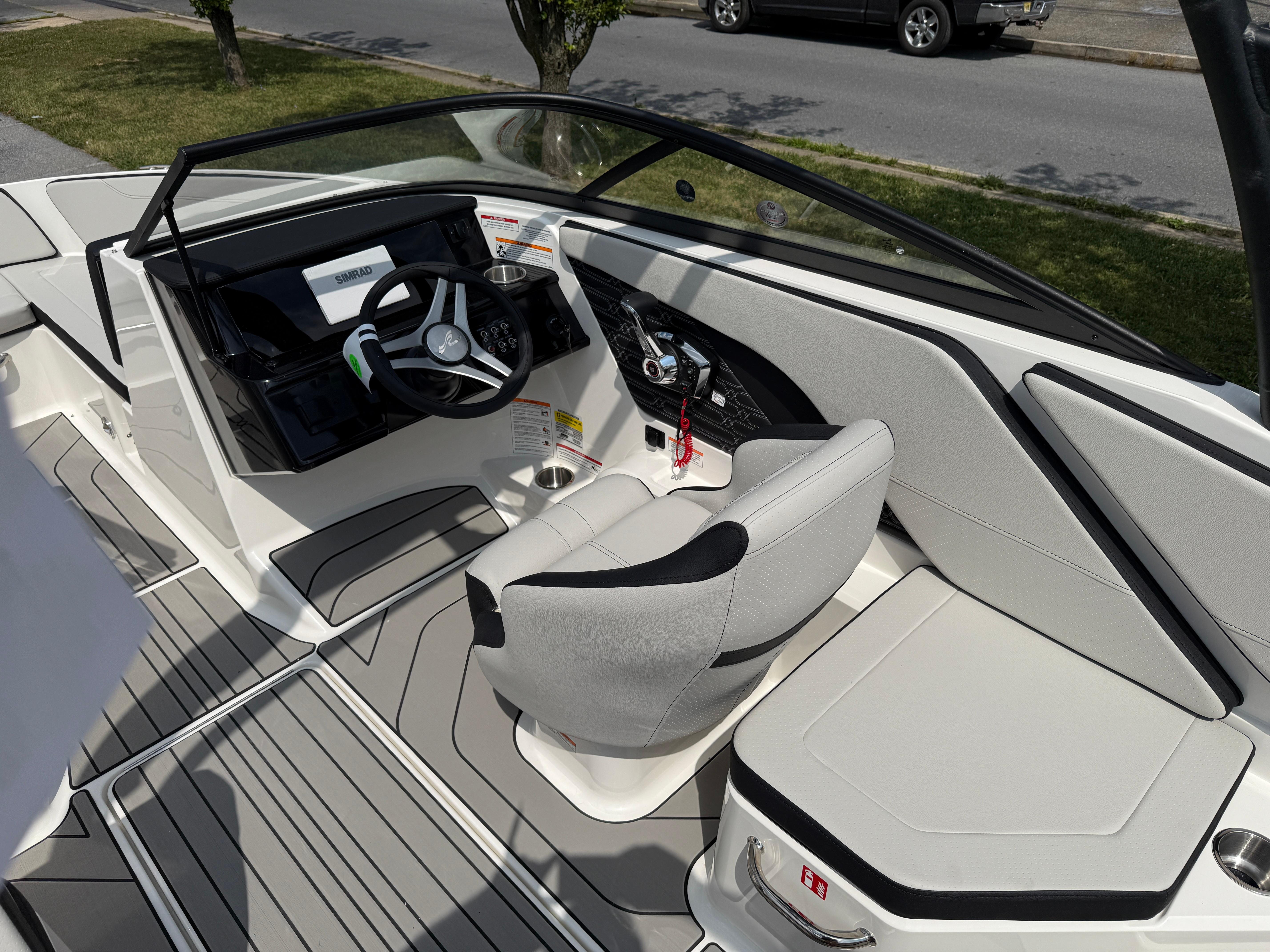 2026 Sea Ray SPX 210 Outboard boat interior with modern steering and seating.