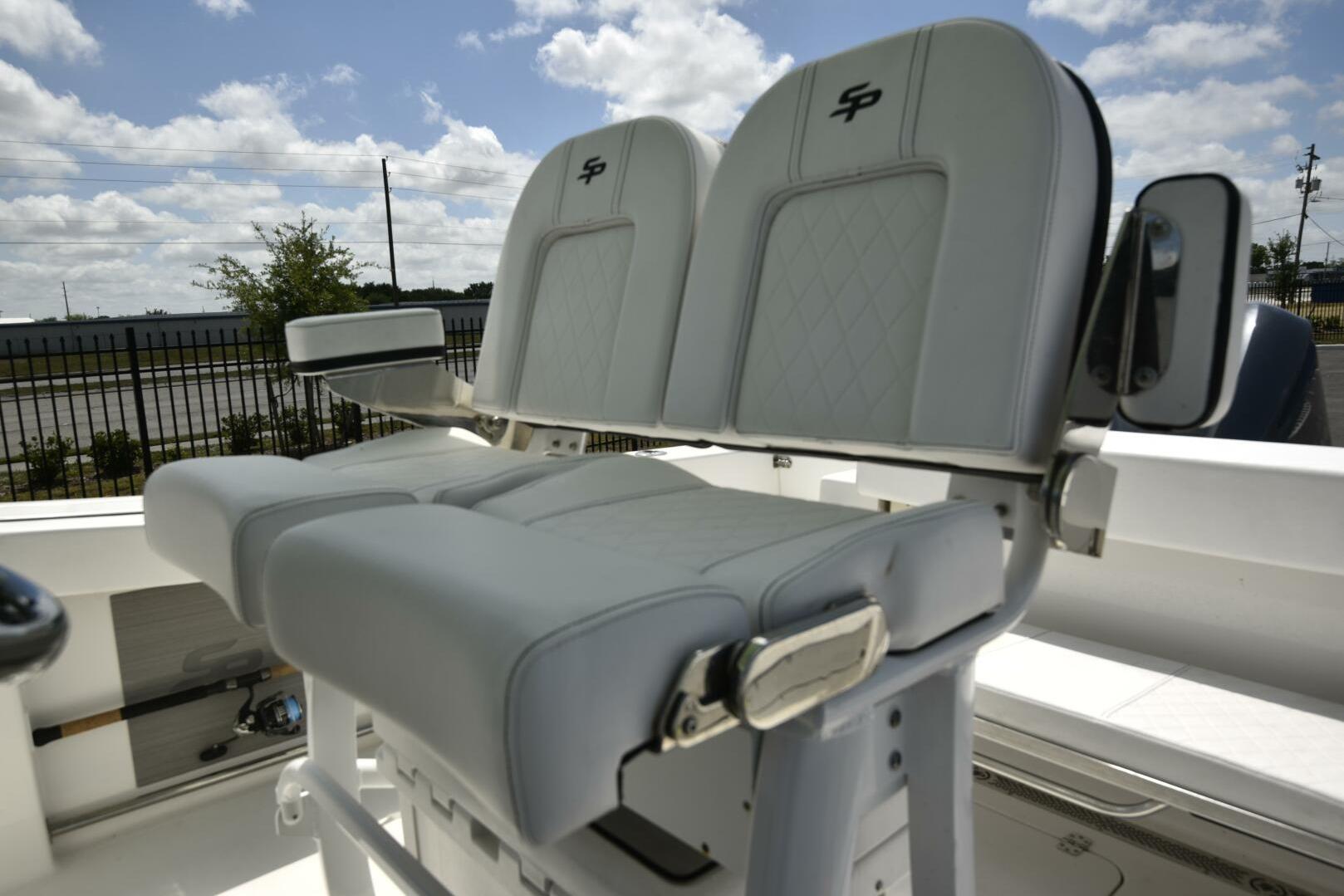 2023 Sea Pro 239 Deep V CC boat seats with armrests under a blue sky.
