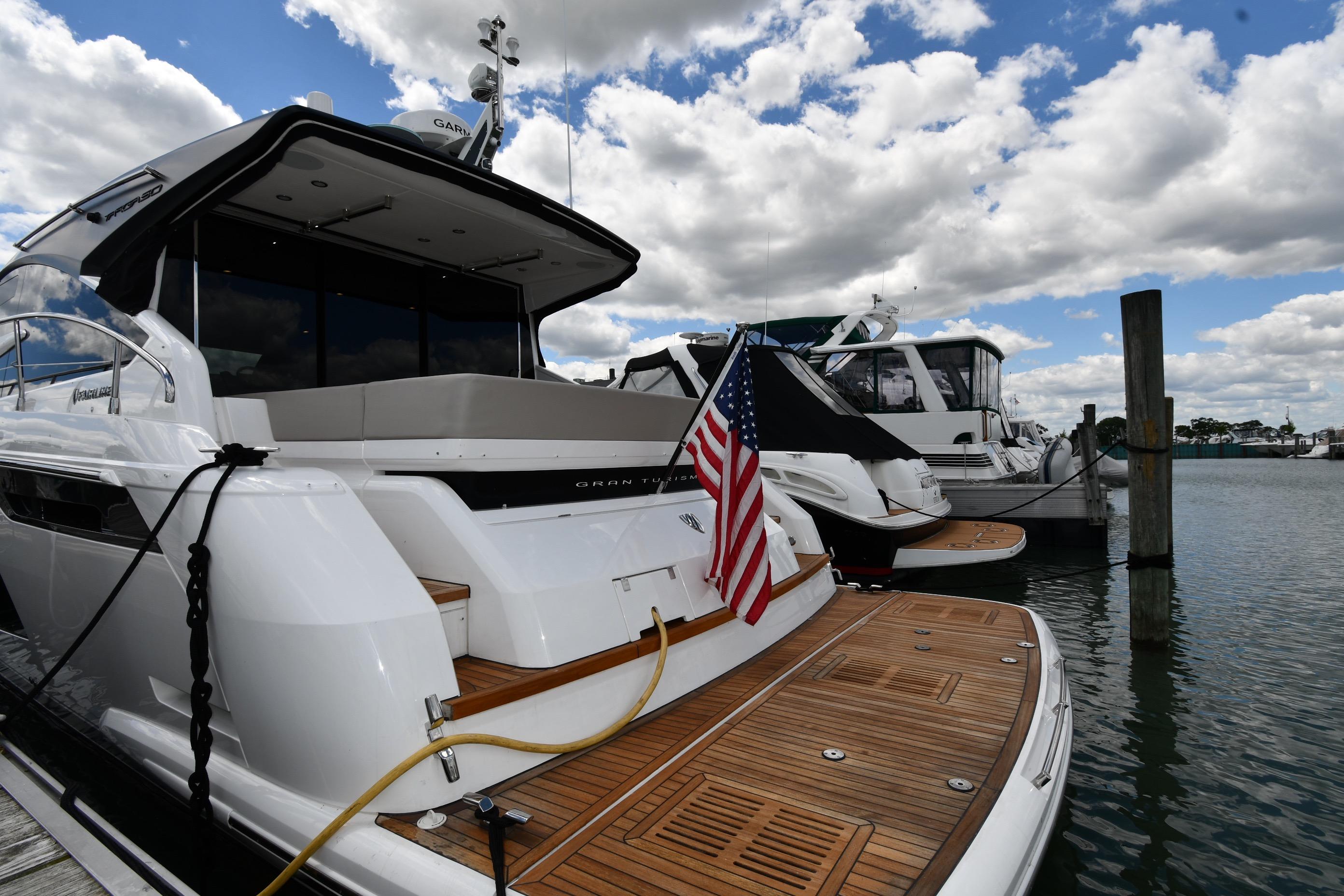 2024 Fairline G50 Targa yacht docked, featuring sleek design and American flag.