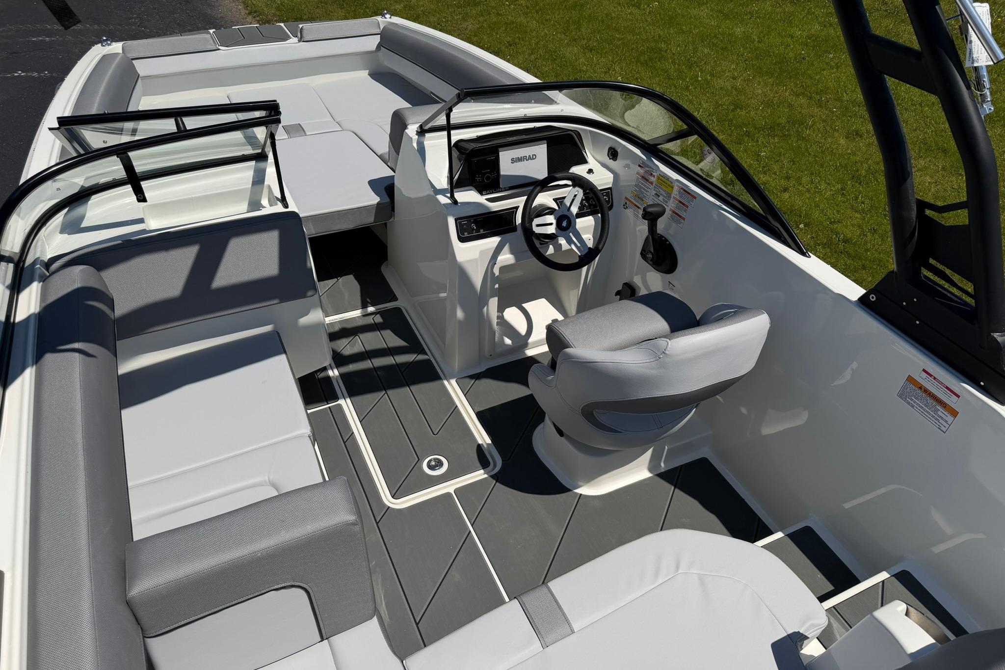 2026 Bayliner D20 boat interior with modern seating and steering console.