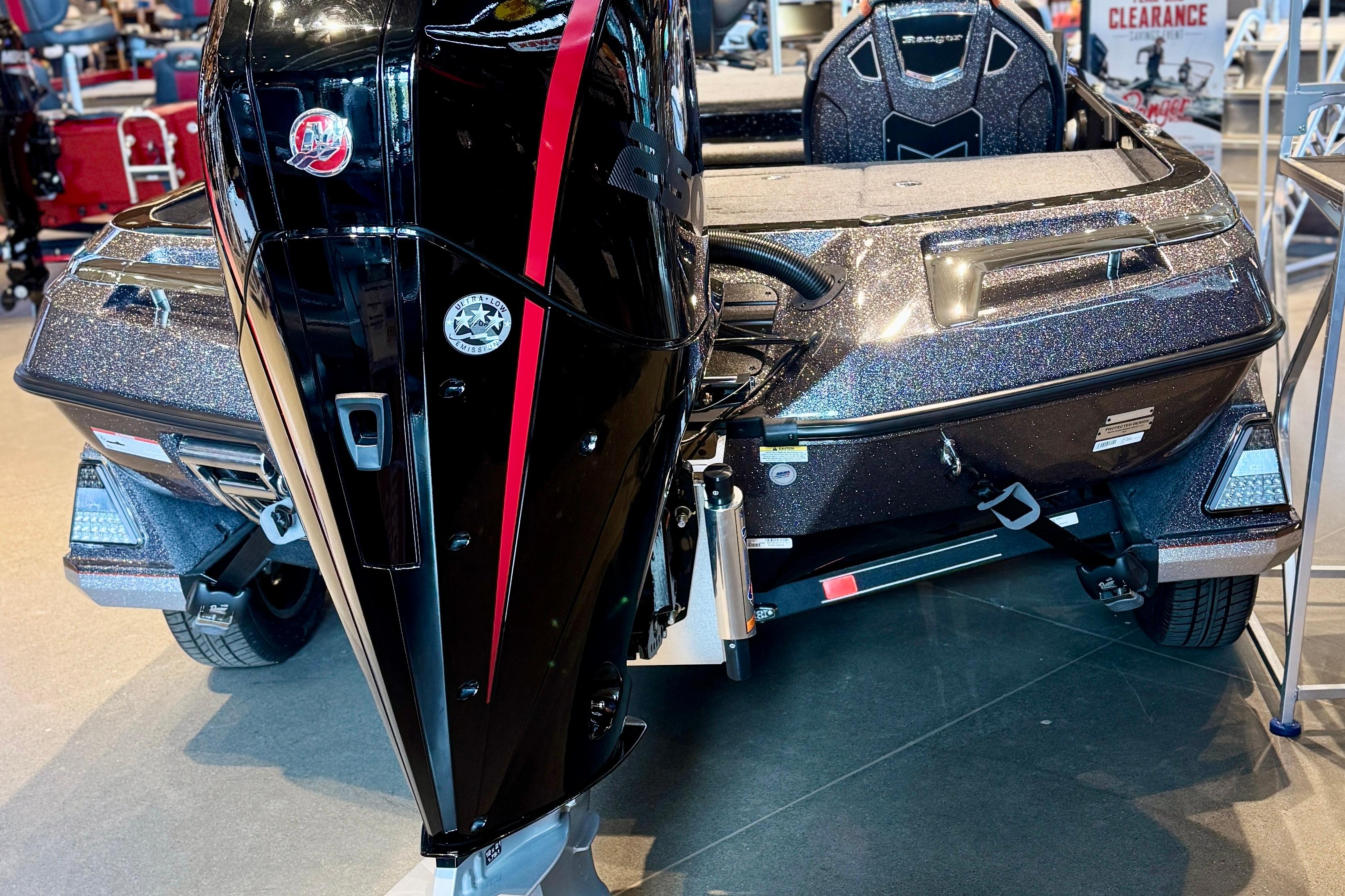 2025 Ranger Z520 boat with sleek black and red motor, displayed indoors.