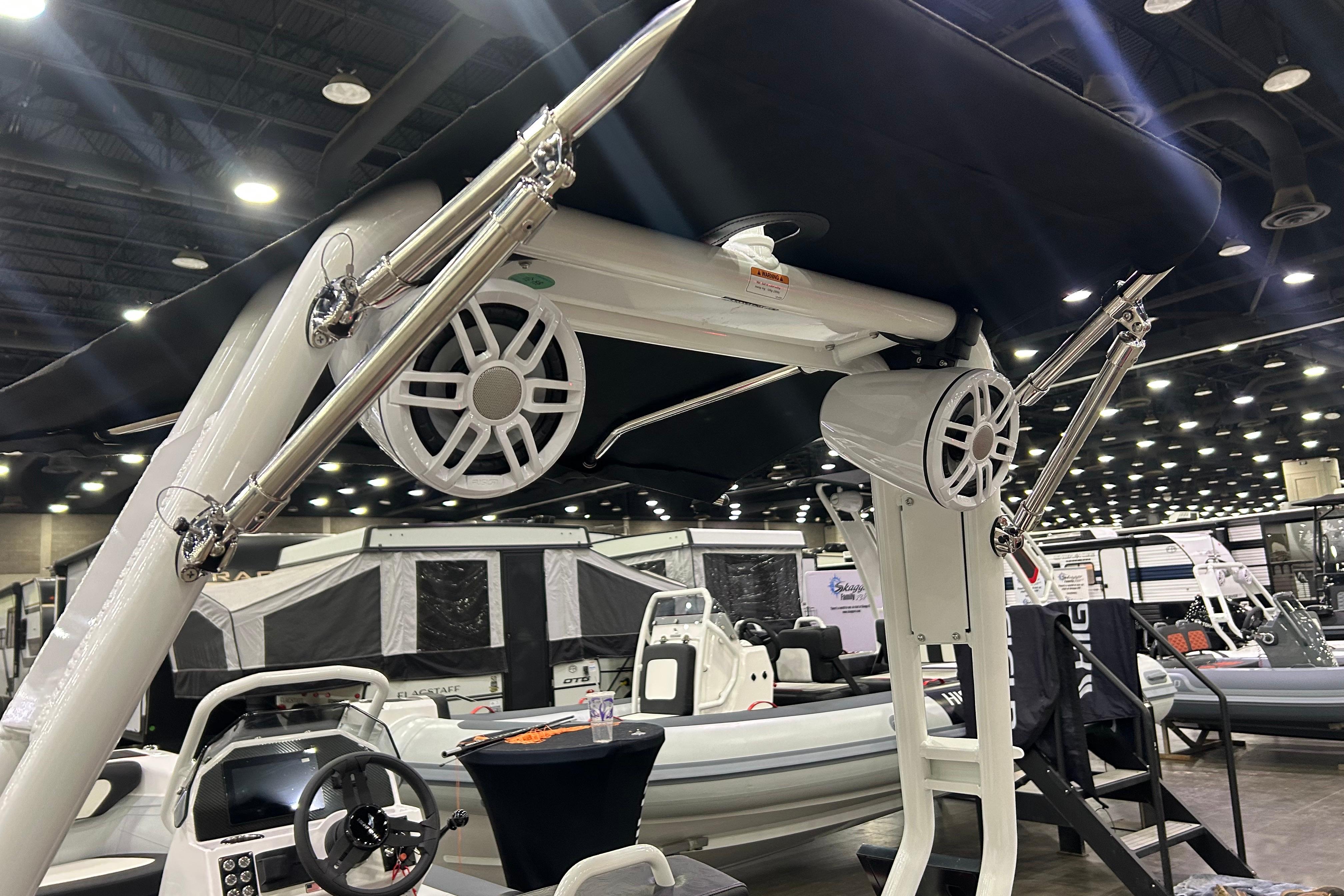 2026 Highfield Velox 420 boat interior with speakers and steering wheel at a boat show.