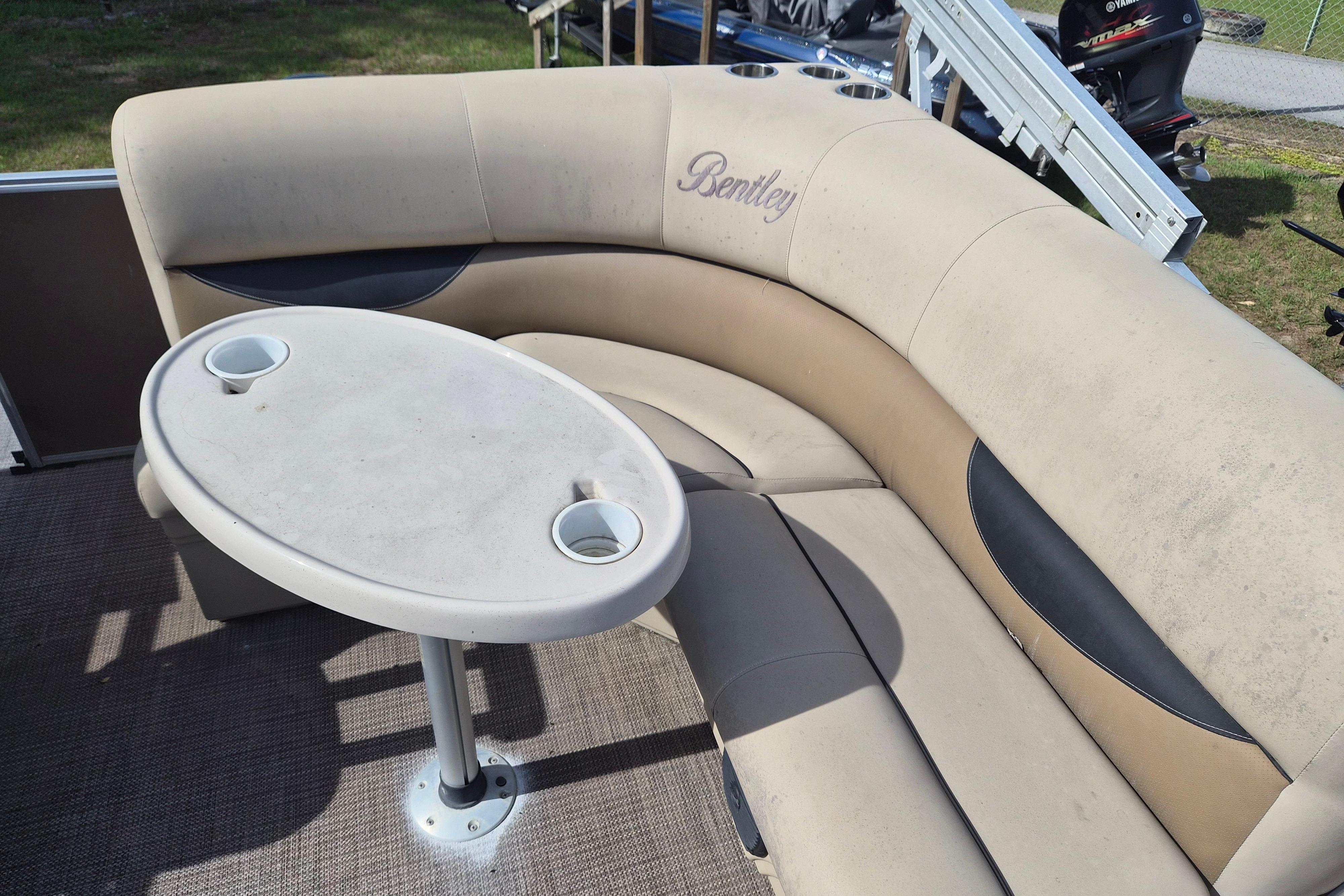 2004 Bentley Pontoons 180 CRUISE interior with beige seating and oval table.