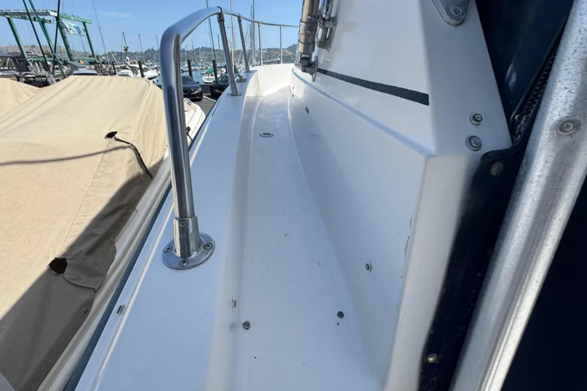 1990 Grady-White Marlin 280 boat deck with railing in marina setting.