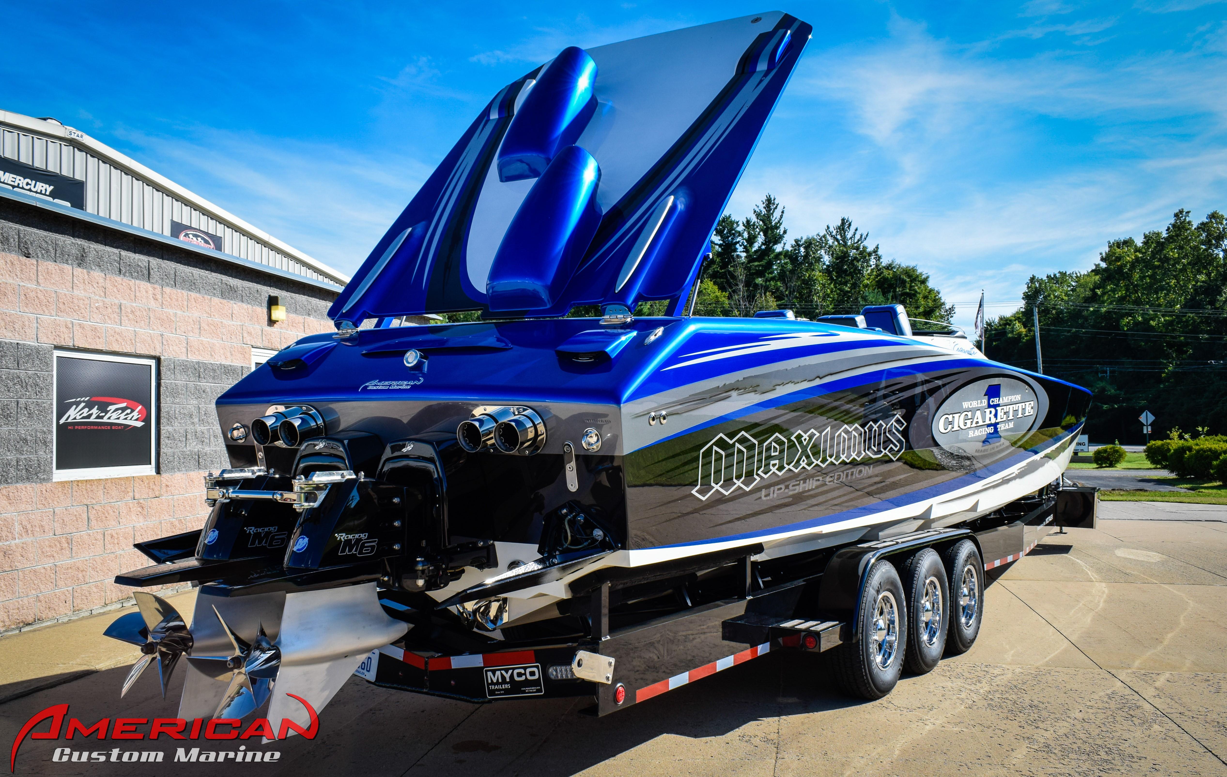 2005 Cigarette 45 Maximus powerboat on trailer, vibrant blue and black design, at American Custom Marine.