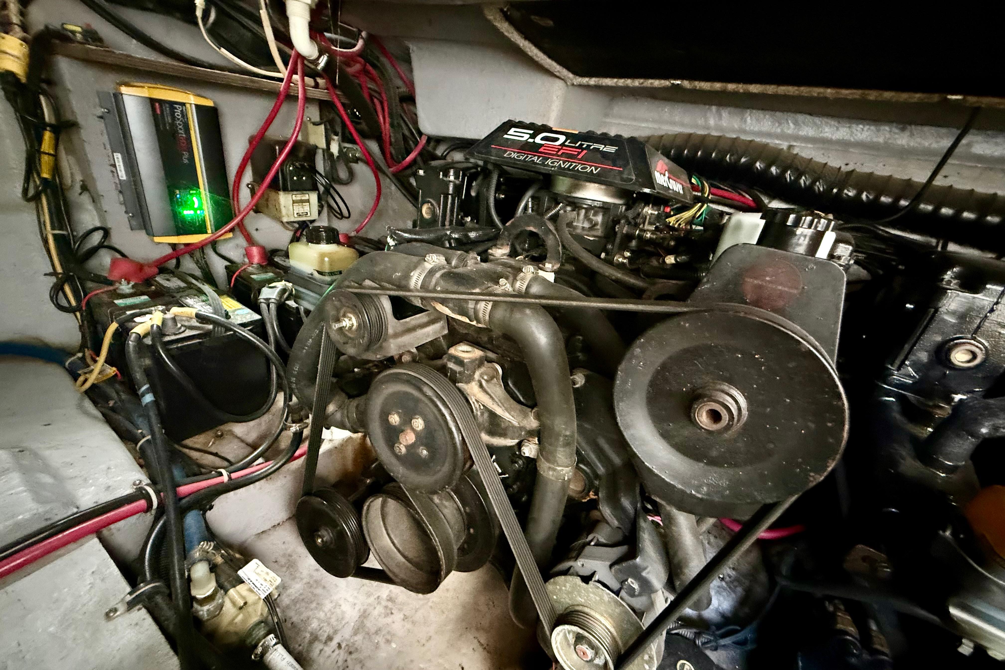 Engine compartment of a 1999 Chaparral Signature 300 boat, featuring a 5.0L EFI engine.