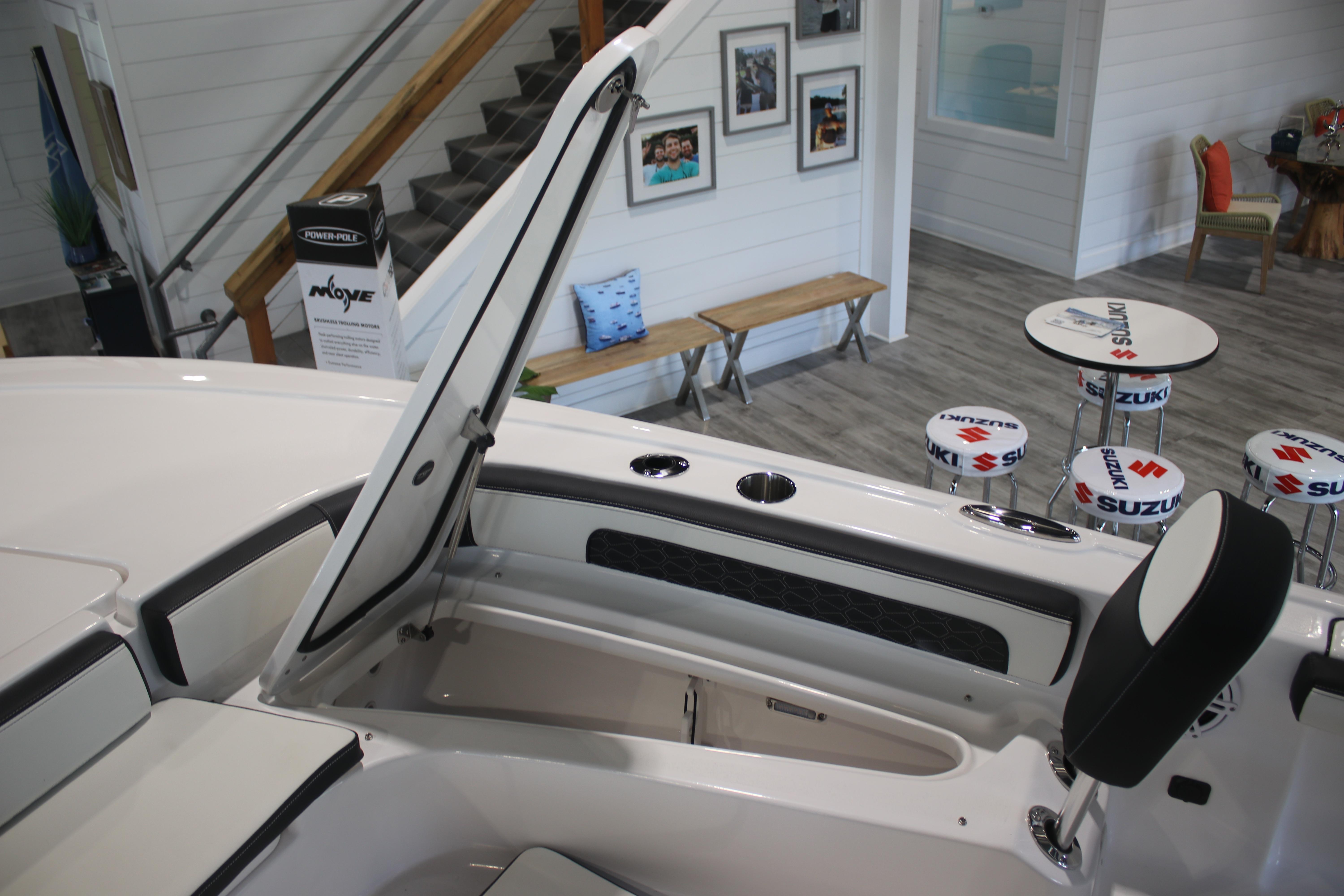 2026 Tidewater 2300 Carolina Bay boat interior with open storage compartment in showroom.