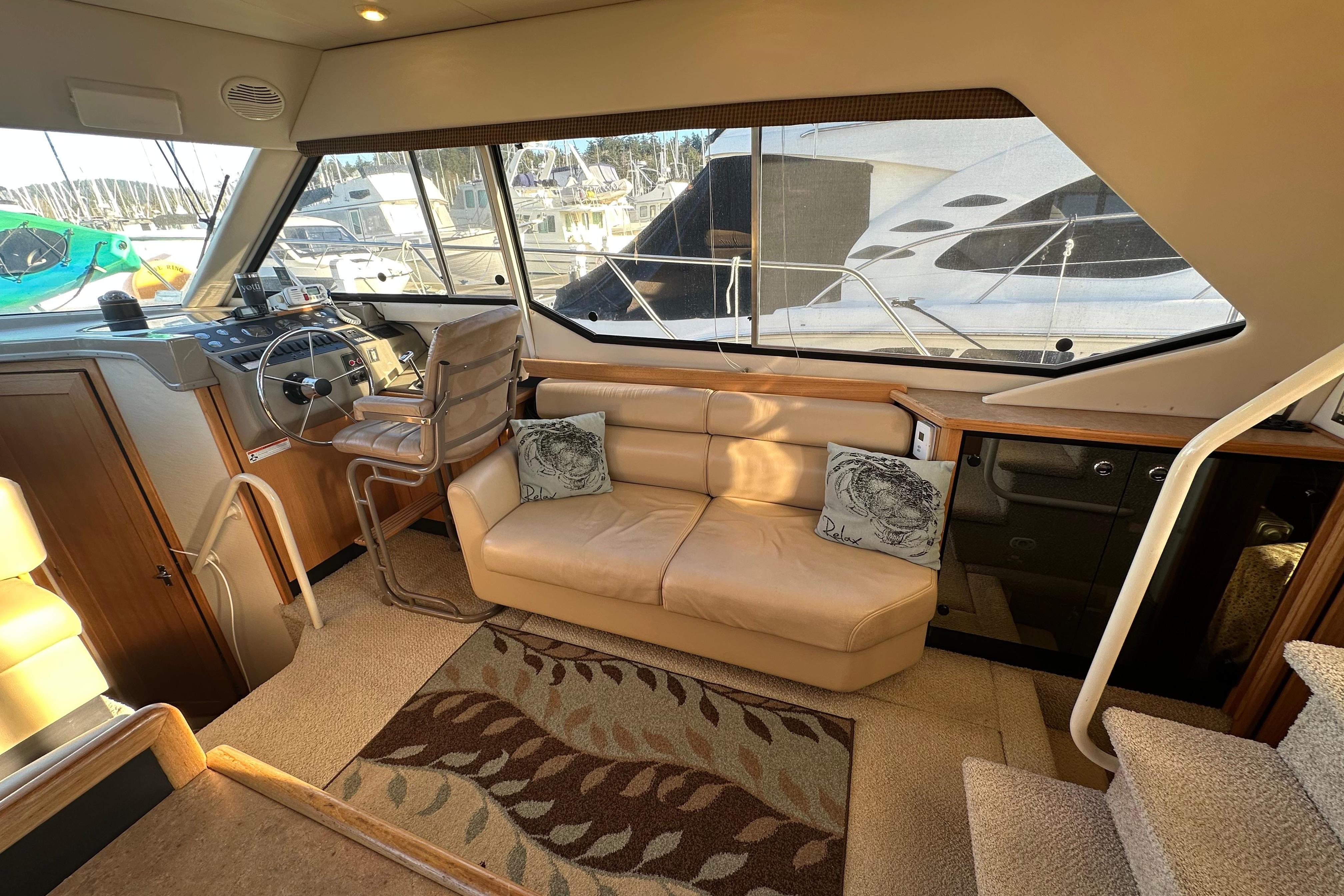Interior of 2000 Bayliner 4087 Aft Cabin Motoryacht with helm, seating, and large windows.