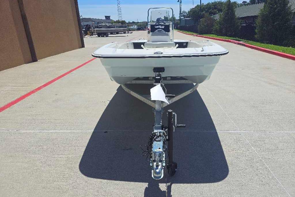2026 Mako Pro Skiff 17 CC boat on trailer, parked on concrete pavement.