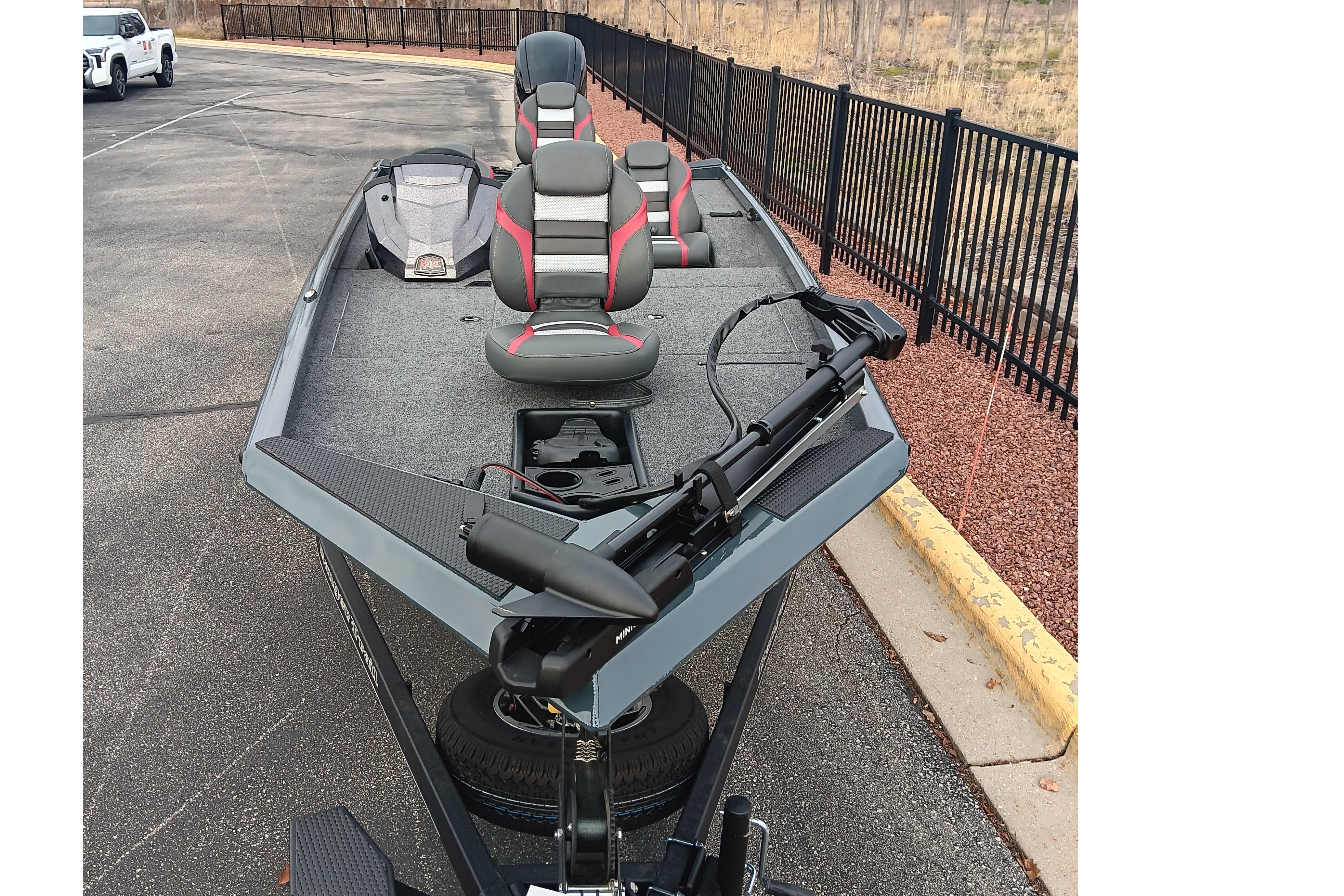 2026 Ranger RT188 fishing boat with seating and trolling motor, parked on pavement.