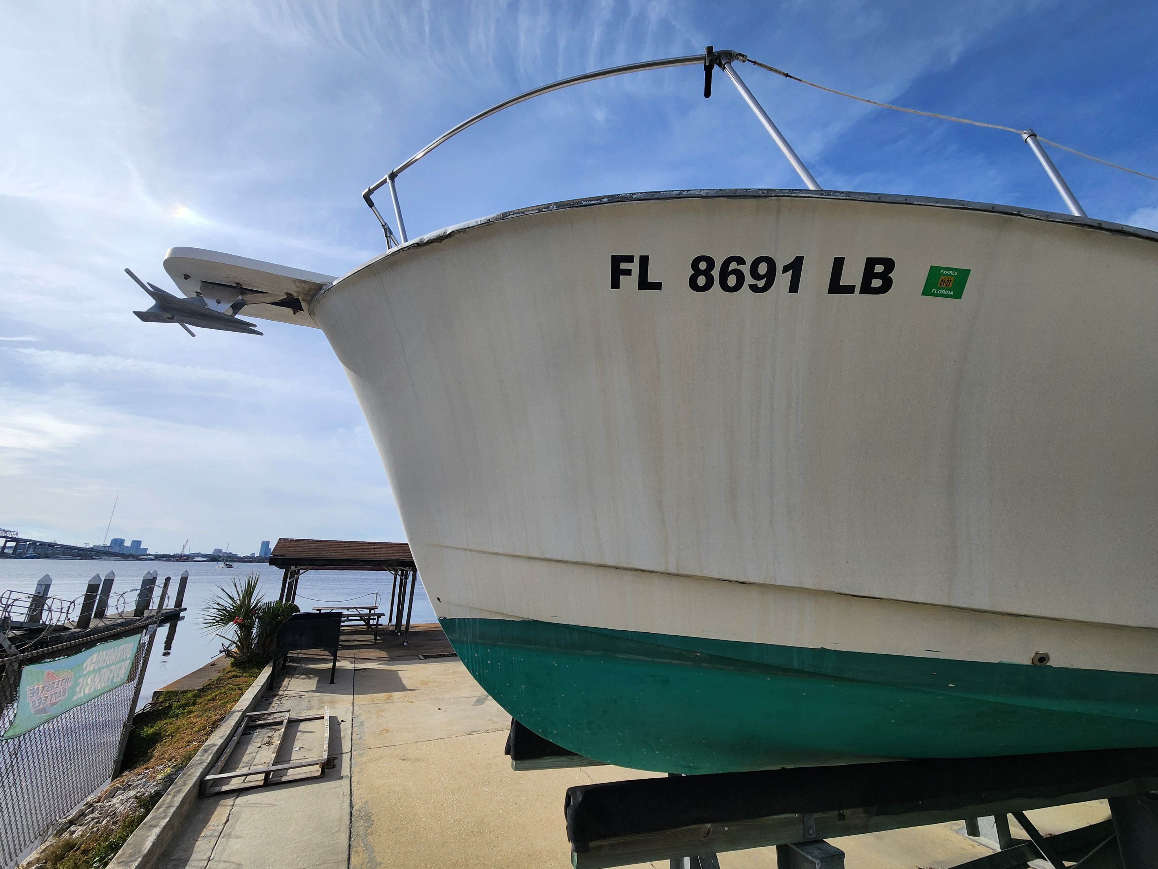 1967 Hatteras 28ft boat docked with waterfront view.