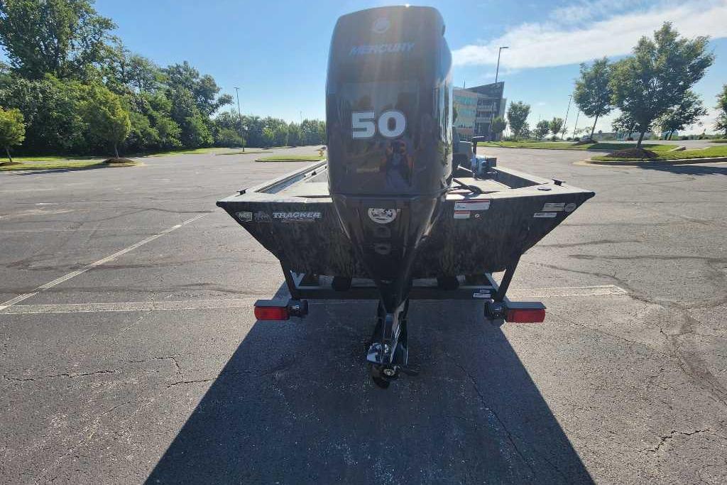 2026 Tracker Grizzly 1648 SC boat with Mercury 50 engine in parking lot.