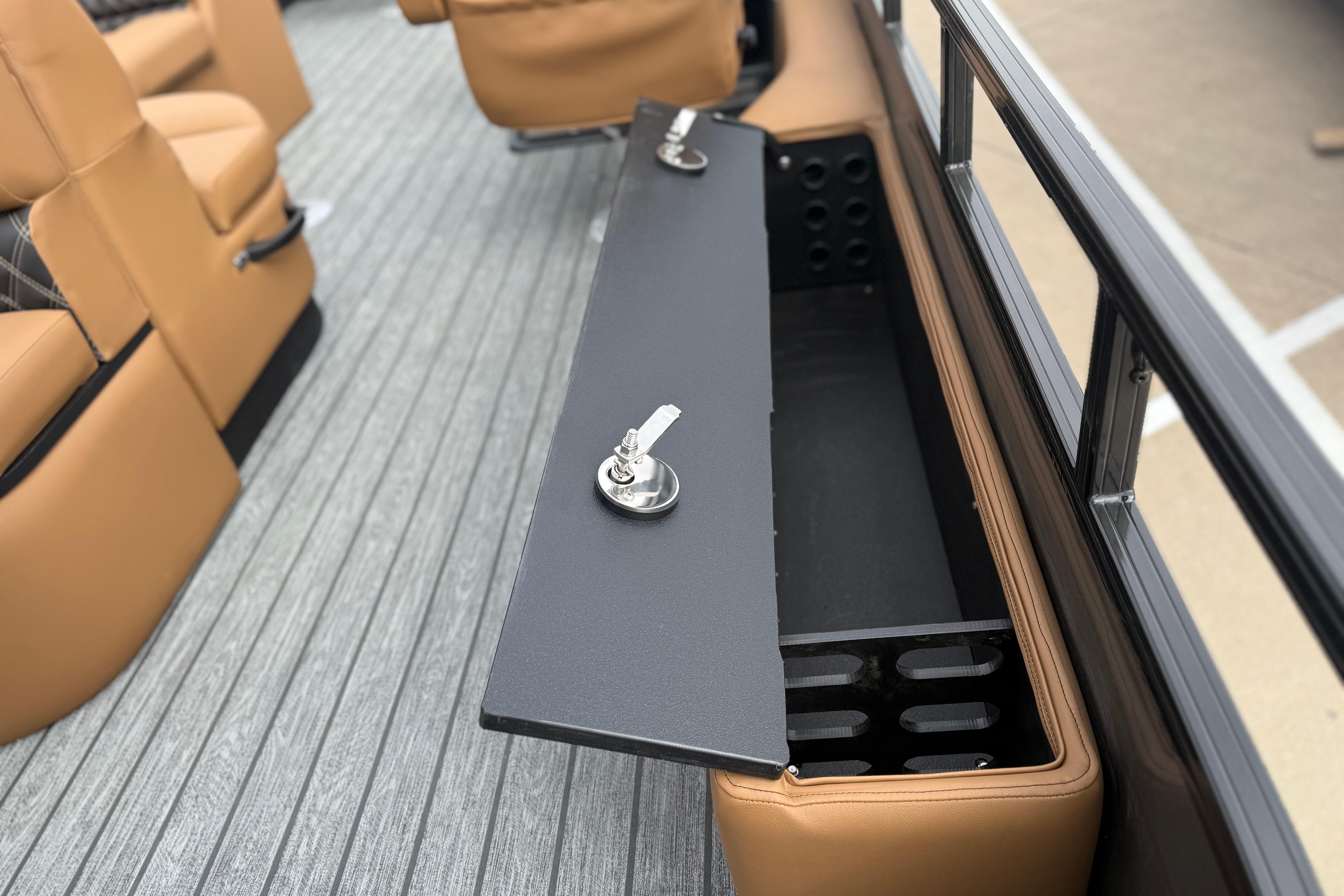2026 Ranger 220F boat interior with open storage compartment and tan seating.