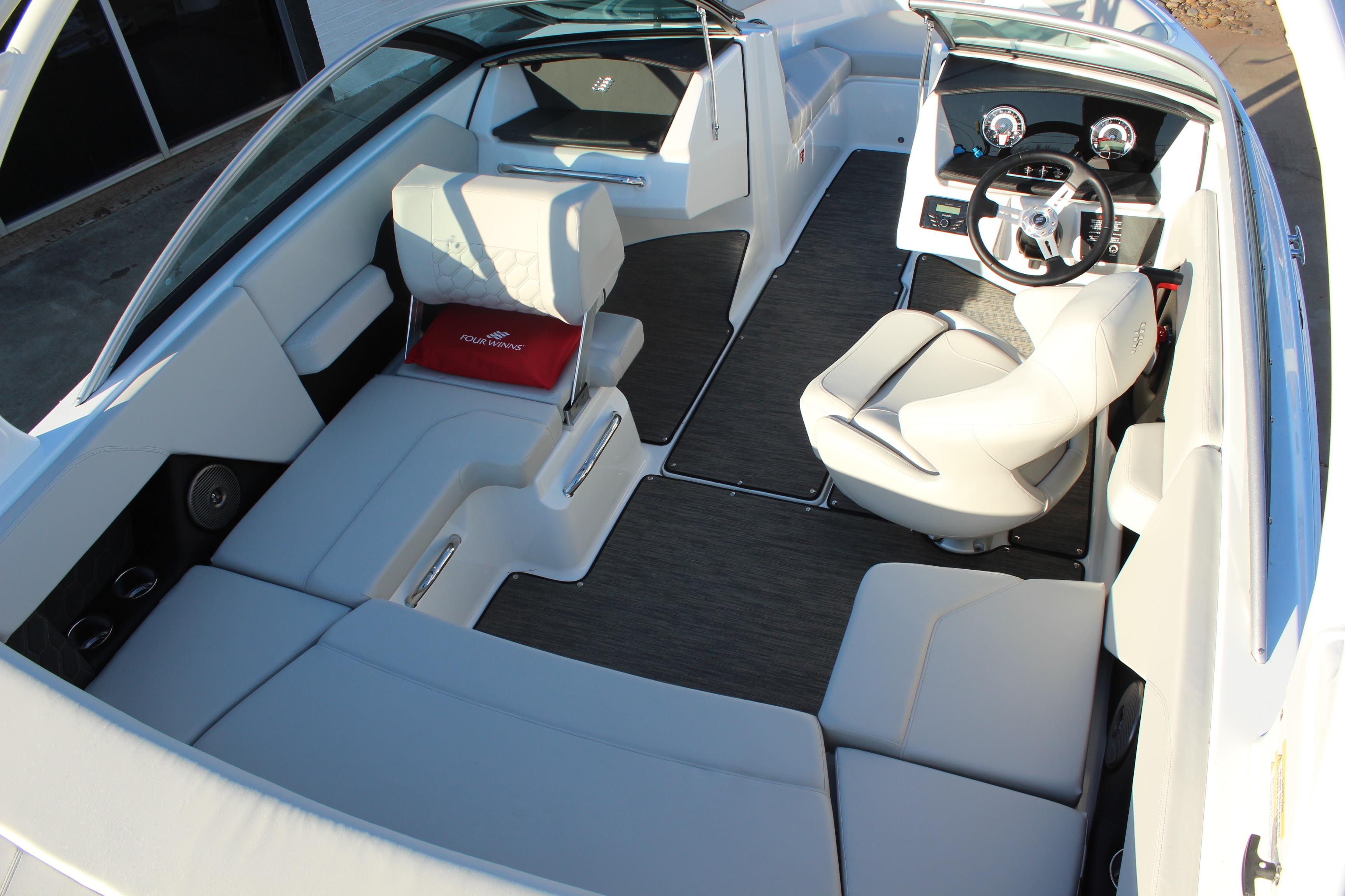 2026 Four Winns H2 Freedom boat interior with modern seating and steering console.