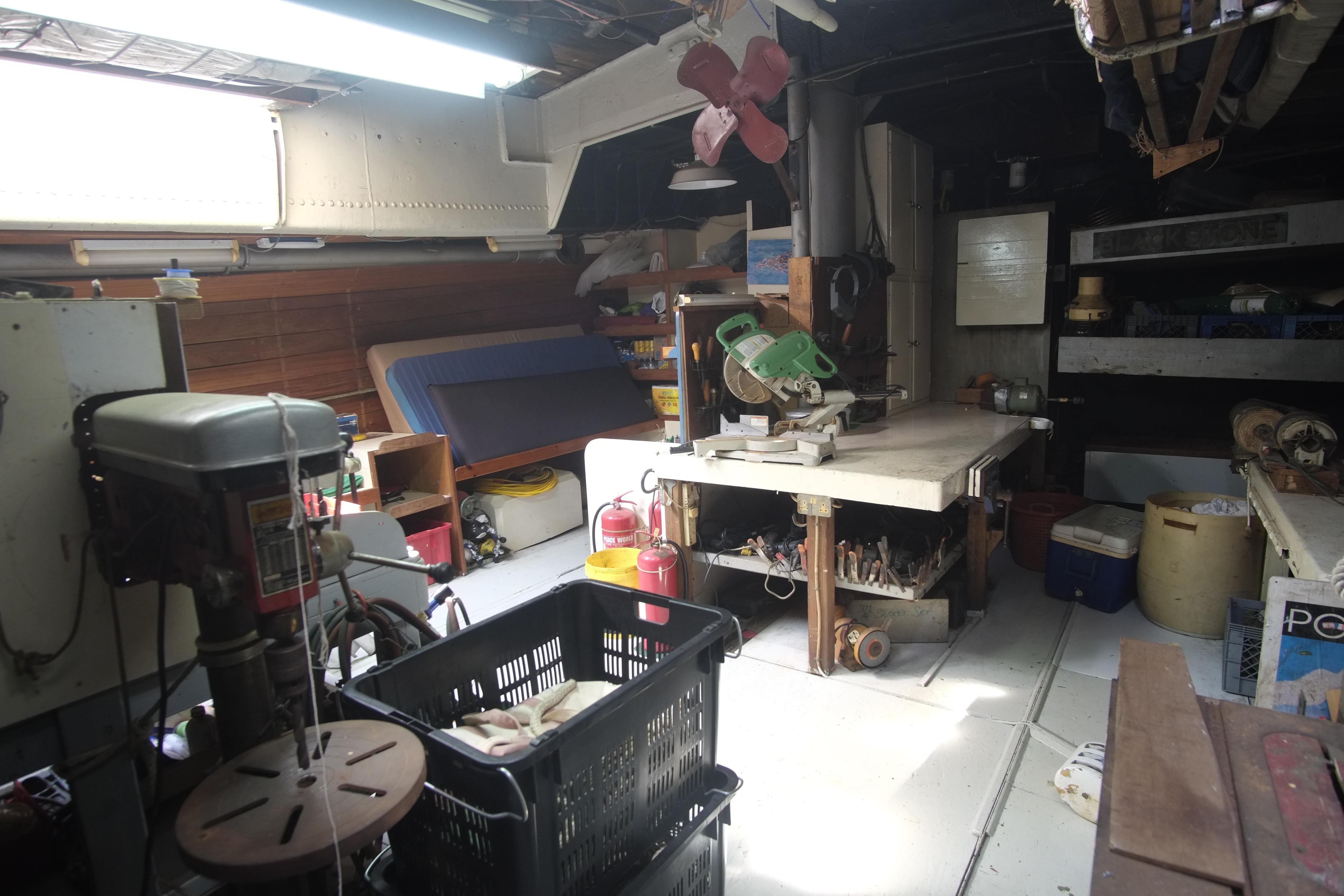 Workshop interior with tools, storage, and a 1930 Custom Gronigen model.