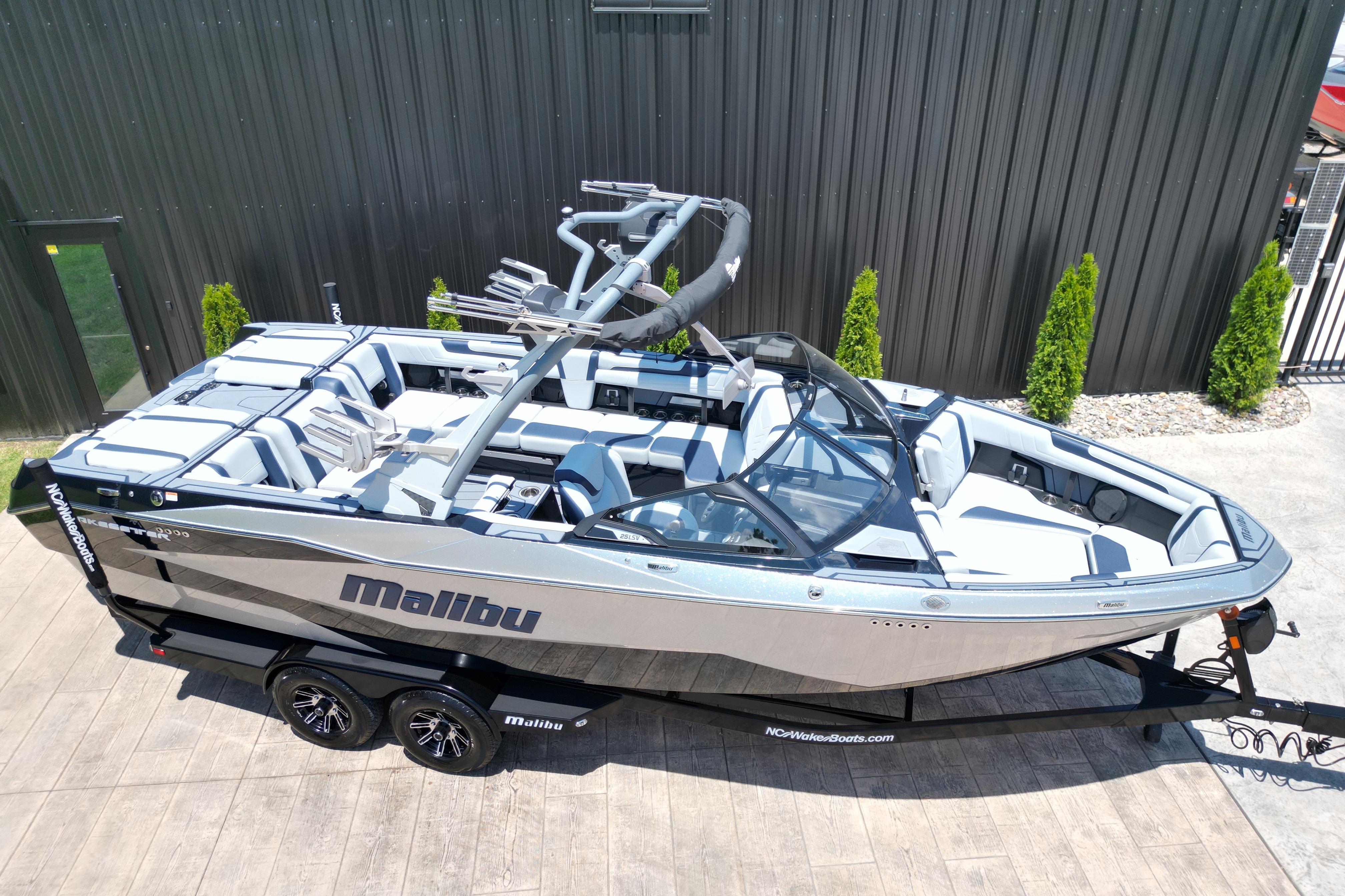 2025 Malibu Wakesetter 25 LSV boat on trailer, sleek design, outdoor setting.