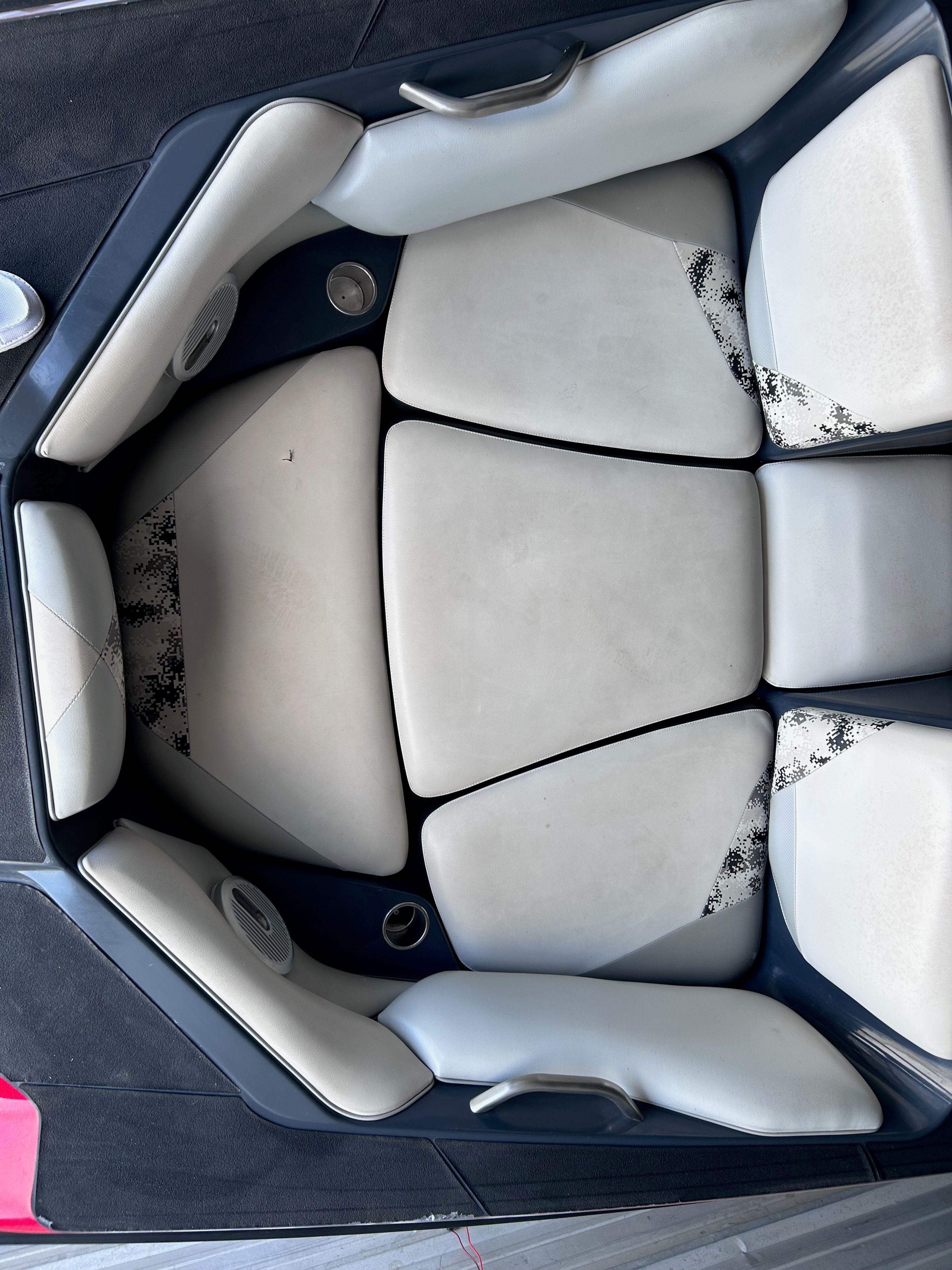 Interior of a 2013 Axis A22 boat with white upholstery.