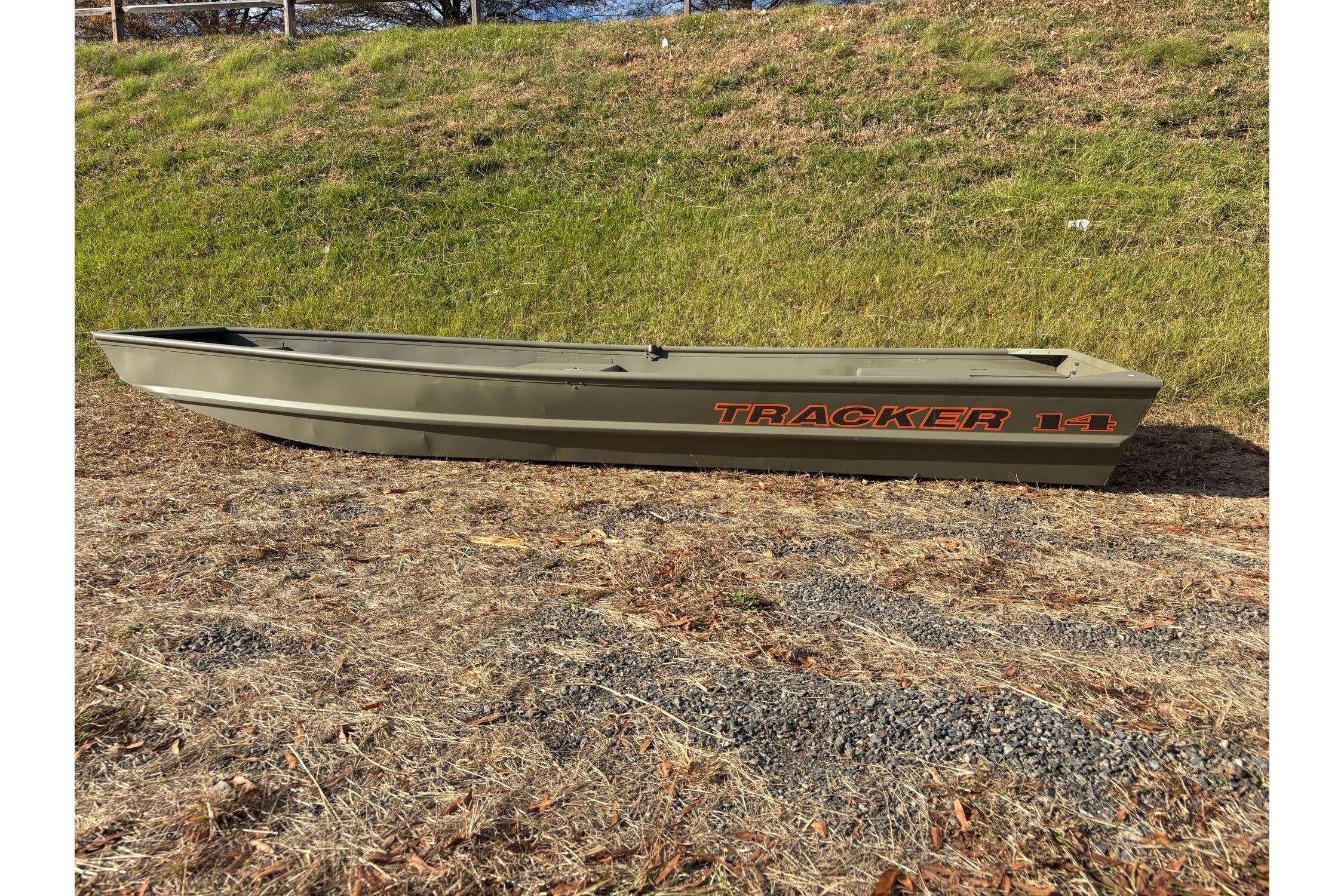 2026 Tracker Grizzly 14 Jon boat on grassy terrain.