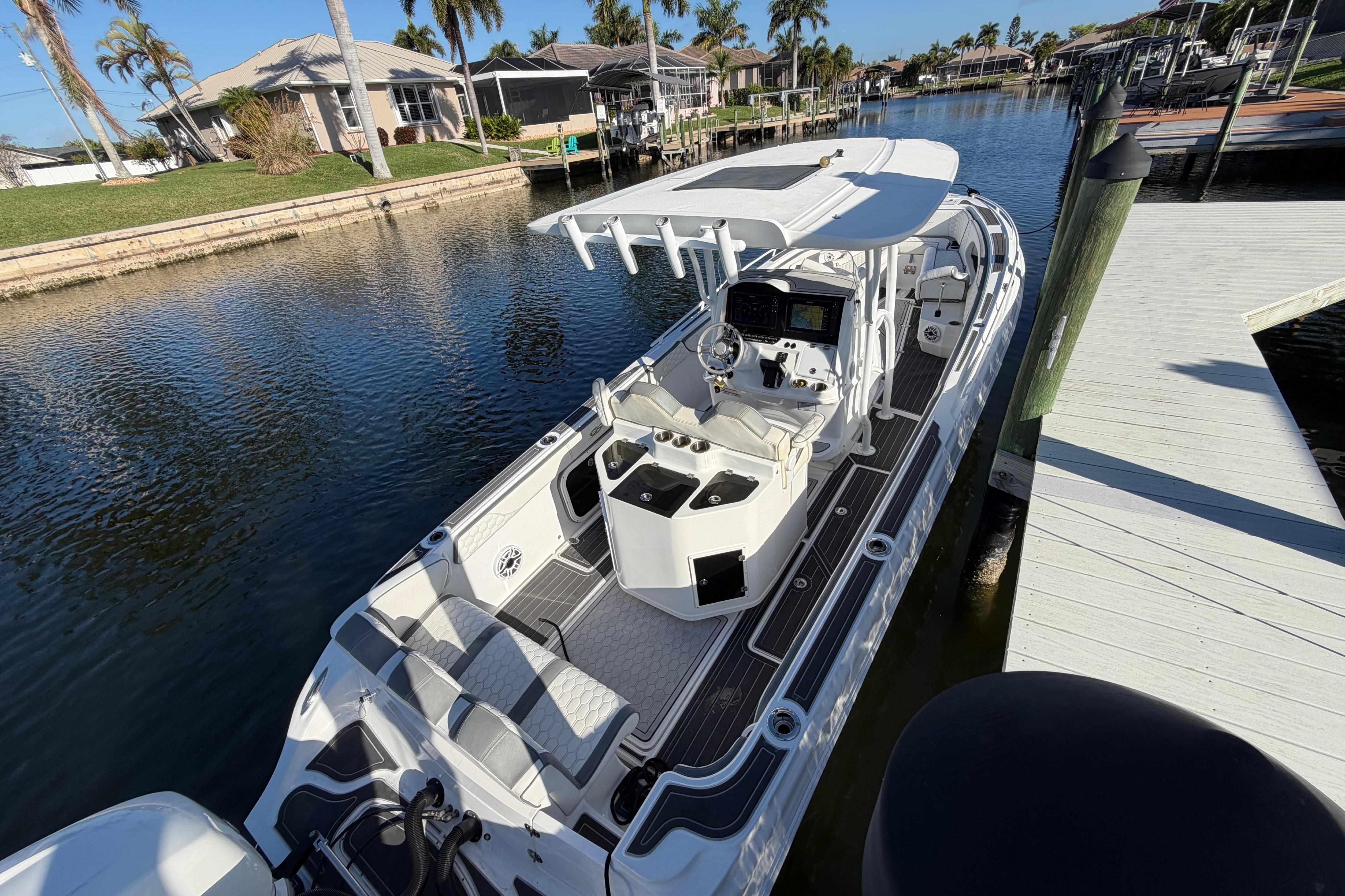 2022 Glasstream 328 Pro-XS boat docked in a scenic canal setting.