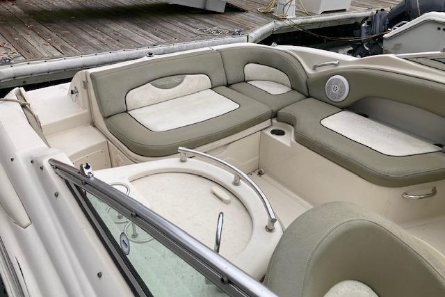 2006 Sea Ray 270 Sundeck boat interior with cushioned seating and speaker.