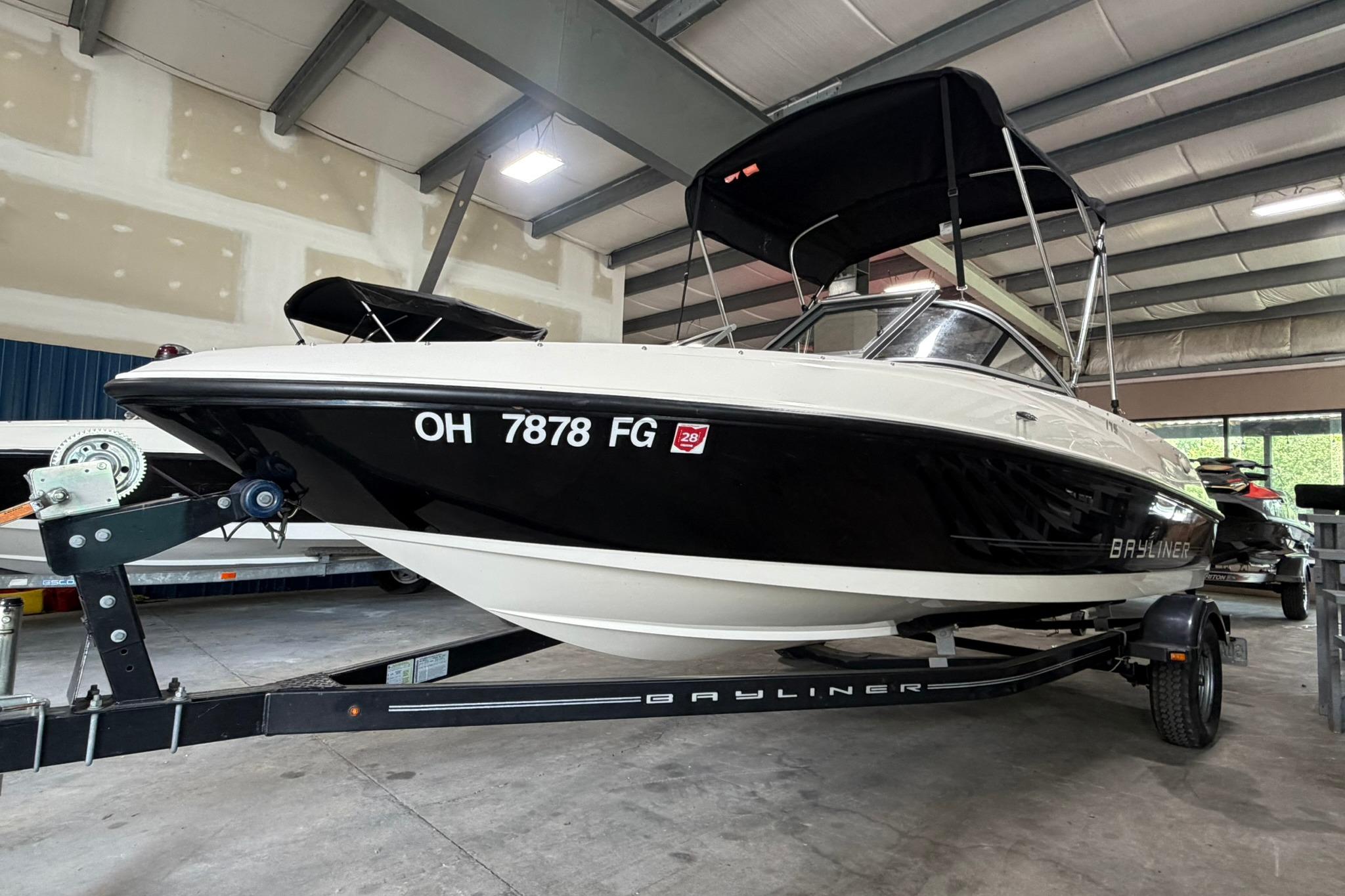 2012 Bayliner 175 Bowrider boat on trailer in indoor storage facility.