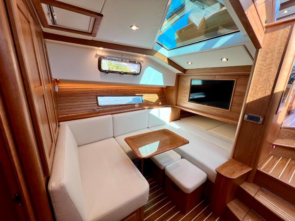 Luxurious interior of 2025 Sabre 43 Salon Express yacht with modern seating and skylight.