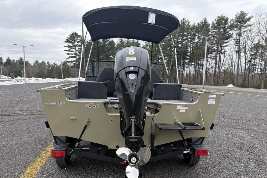 2026 Tracker Targa V-18 Combo boat with outboard motor, parked outdoors.