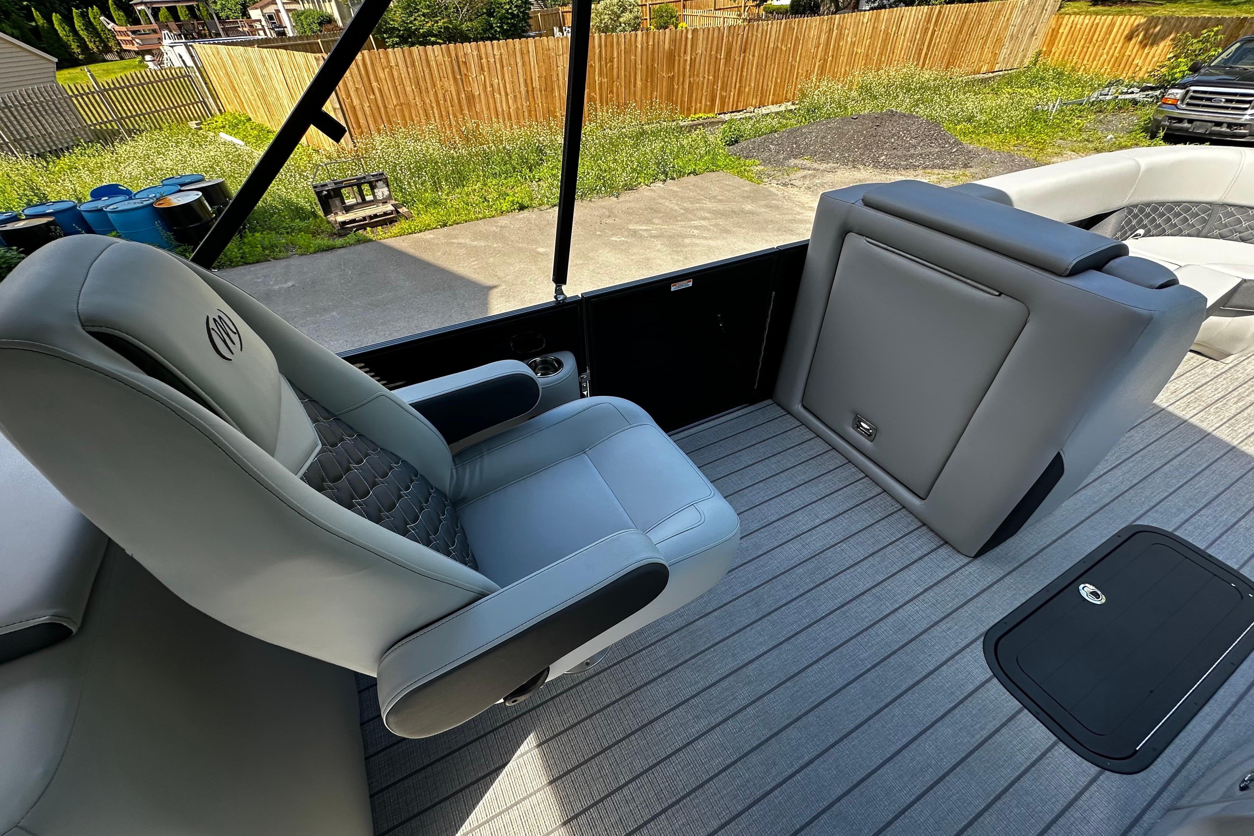 2027 Manitou 25 Encore RF boat interior with gray seating and sleek design.